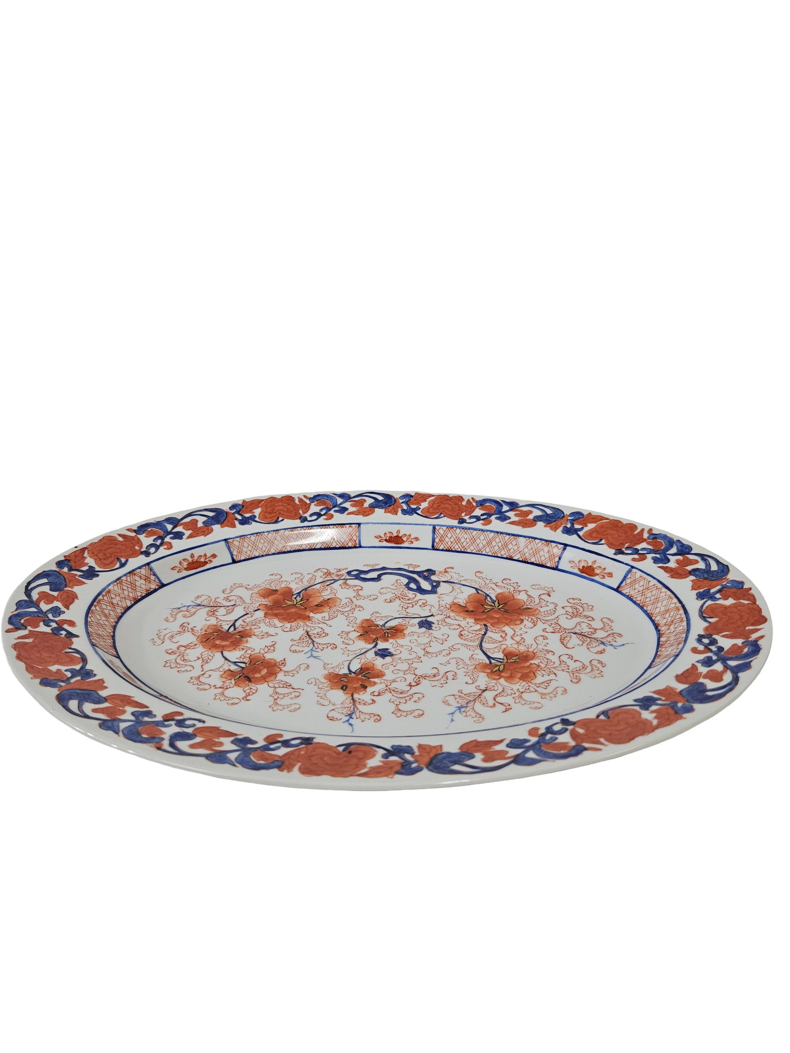 Large Imari Style Porcelain Platter: This large oval porcelain serving platter features a classic Japanese Imari-inspired palette of iron red, cobalt blue, and gold accents. The central medallion and border are decorated with flowering p
