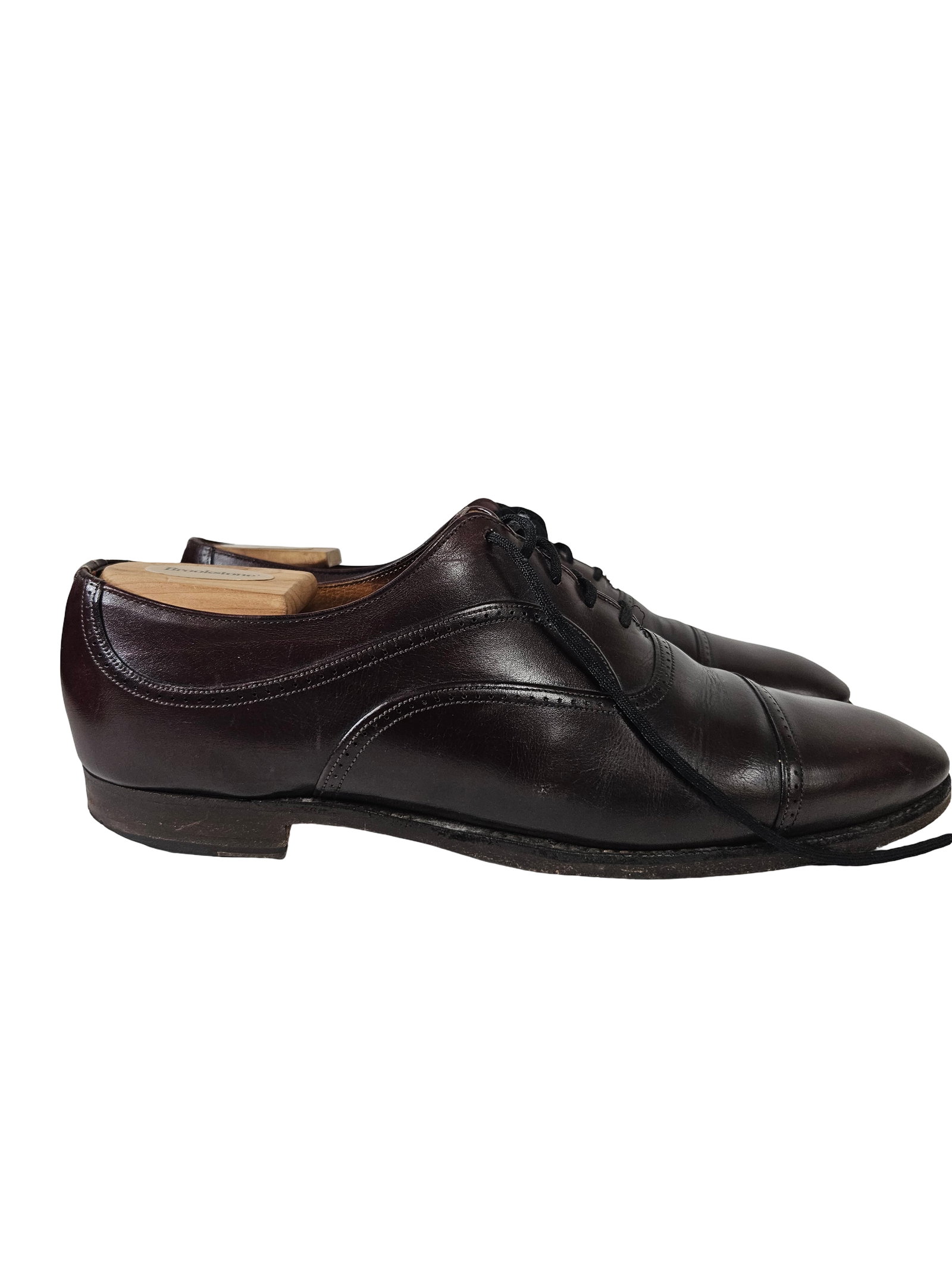Men's Leather Cap-Toe Oxford Shoes: A pair of classic men's cap-toe Oxford dress shoes crafted from dark burgundy leather with subtle brogue detailing along the seams. These shoes feature a traditional lace-up closure and are paired