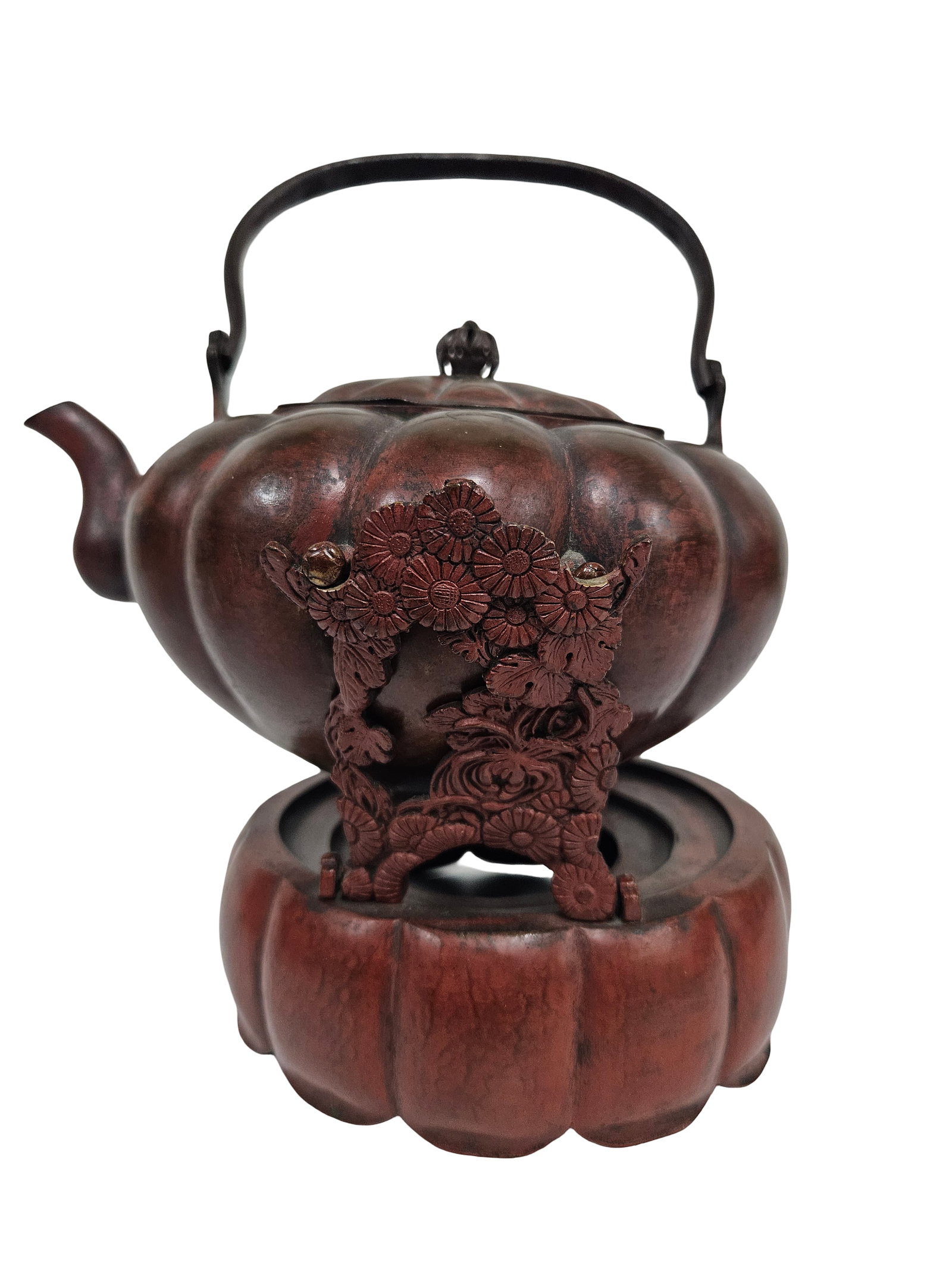 Japanese Style Lobed Teapot and Base: This cast metal teapot and matching warming base feature a distinctive lobed pumpkin or melon form with a textured reddish-brown patina. The exterior is embellished with intricate applied floral motif