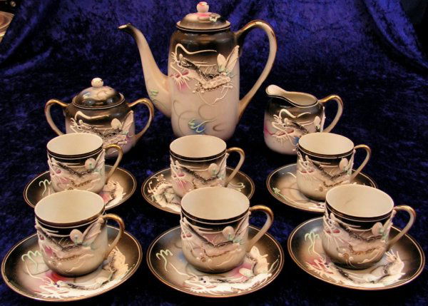 Japanese Geisha Kutani Porcelain Dragon Tea Set: KUTANI - GEISHA GIRL LITHOPHANES "Dragonware" mid 20th century. This is a set of 15. These Lithophanes occurs almost exclusively on the bottoms of tea cups. This marking span from the late 1930's and