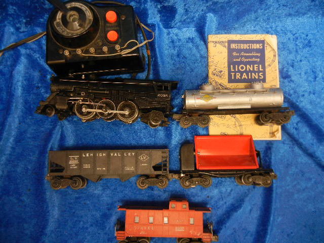 Lionel Train Set with Five Trains and Tracks C1948: Lionel Train Set with Engine, Gas Tanker, Caboose, a Coal Car, a Regular Storage Car, and Dump Car, Total of five and a Manual, in Running Condition with Full Set of Tracks