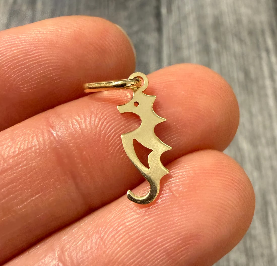 Mini 14K Gold Seahorse Charm: Metal: 14K Yellow GoldWeight: 0.5 gramsMeasurements: 0.55 inches long by 0.25 inches wideMarkings: "14KT ITALY"Condition: In very good condition with only minor surface wear.