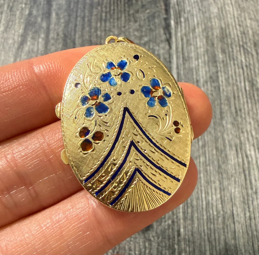 Large Enamel and 14K Gold "Forget Me Not" Locket: Metal: 14K Yellow GoldWeight: 8.4 gramsMeasurements: 1.5 inches long by 1.1 inches wideMarkings: "14K"Condition: In good condition with some enamel loss and minor surface wear consistent with age.