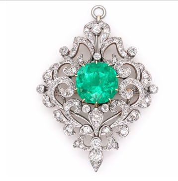 18K Yellow Gold & Platinum Top GIA Certified Colombian Emerald and Diamond Pendant/Brooch: A rare GIA Certified Colombian Emerald (famed for their deep green hue) set in an 18K yellow gold and platinum brooch/pendant.