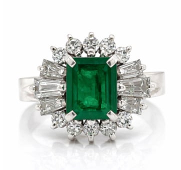 Platinum Emerald & Diamond Ring: A sophisticated platinum ring featuring a center emerald highlighted by fine diamonds.