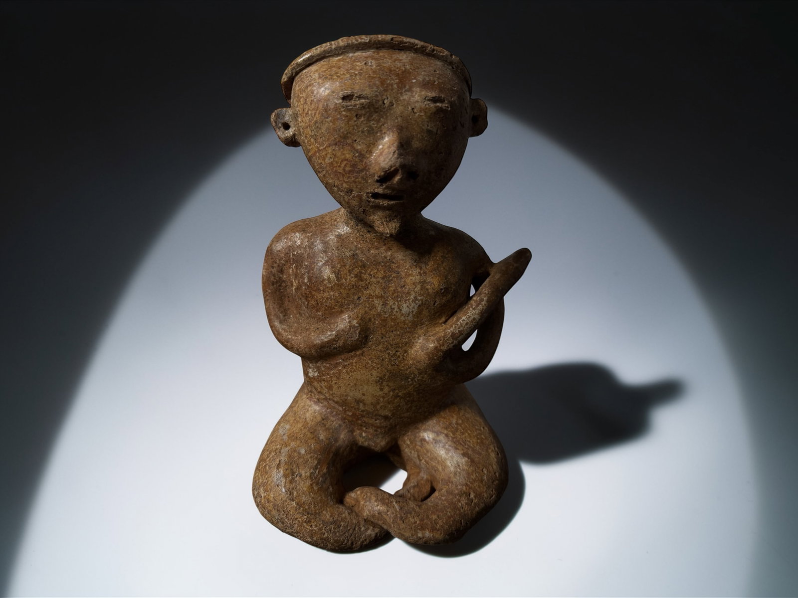 Pre-Columbian Kneeling Figurine: This is an authentic ancient artifact created by early cultures using traditional hand-built methods. The surviving form preserves exceptional historical and archaeological value, showing surface