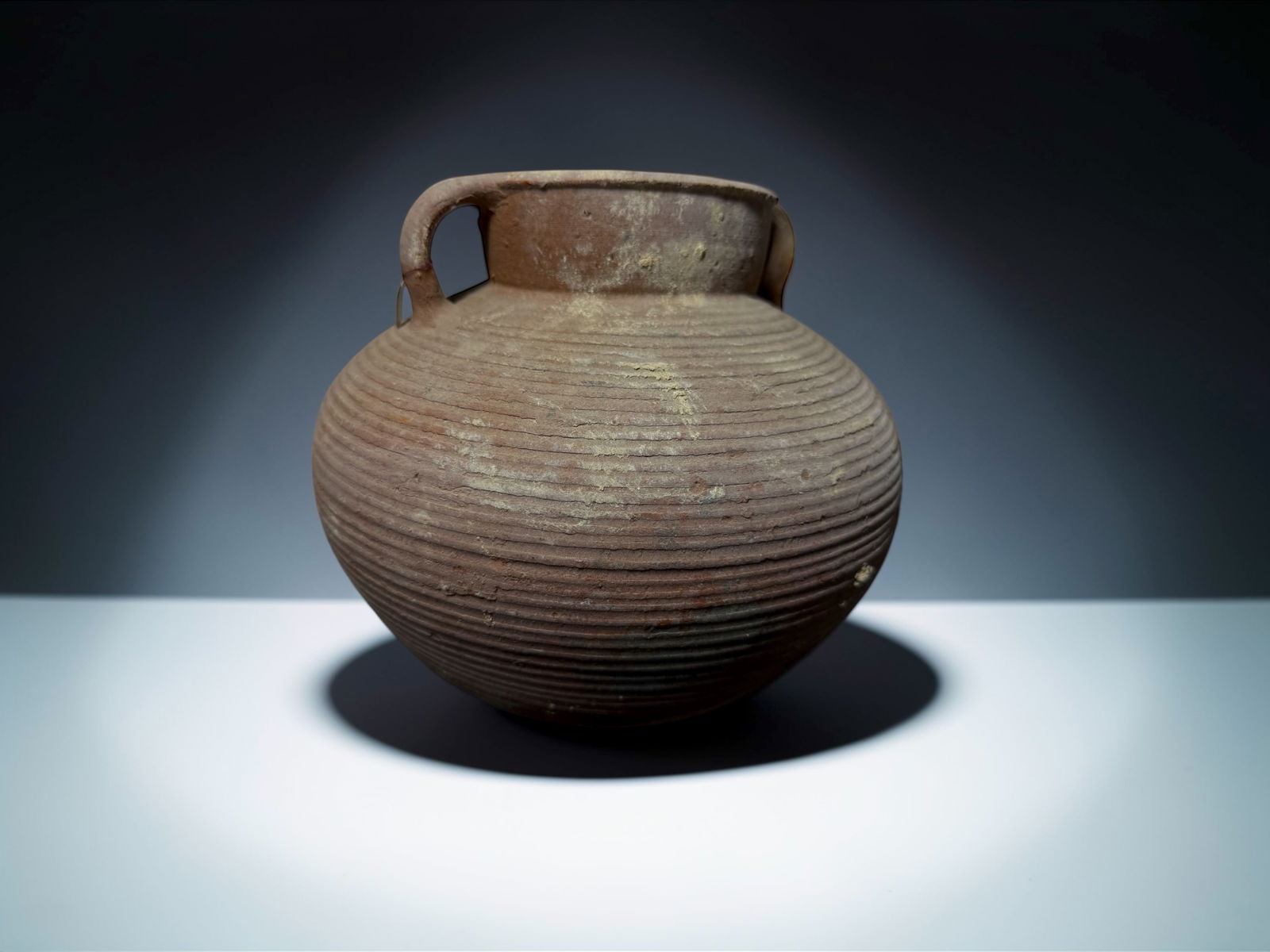 Ancient Ribbed Storage Jar Antiquity: This is an authentic ancient artifact created by early cultures using traditional hand-built methods. The surviving form preserves exceptional historical and archaeological value, showing surface
