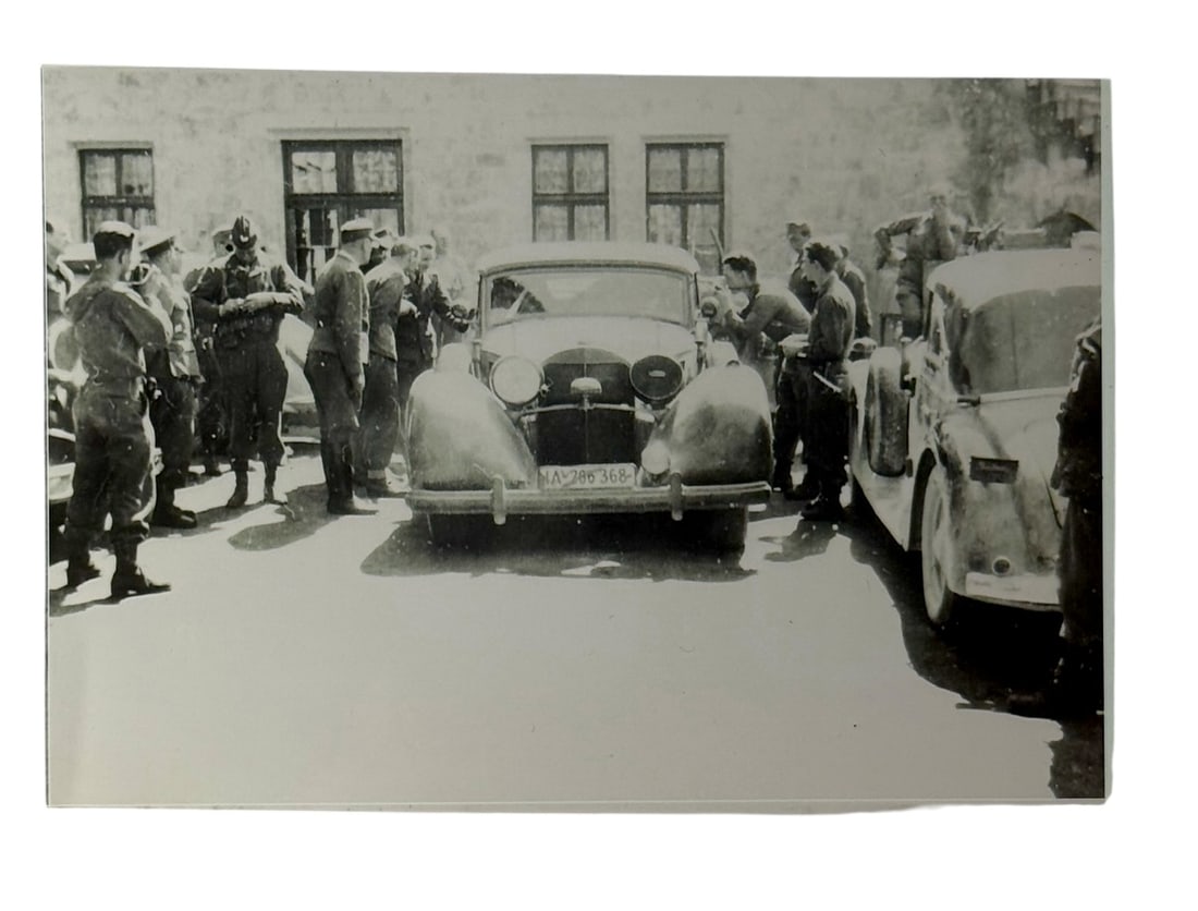 WWII Photograph ? Nazi Staff Car Surrounded by U.S. Soldiers: Rare WWII photograph depicting American troops surrounding a confiscated Nazi staff car. Strong documentary value capturing post_liberation operations, inspection scenes, uniforms, and period vehicles