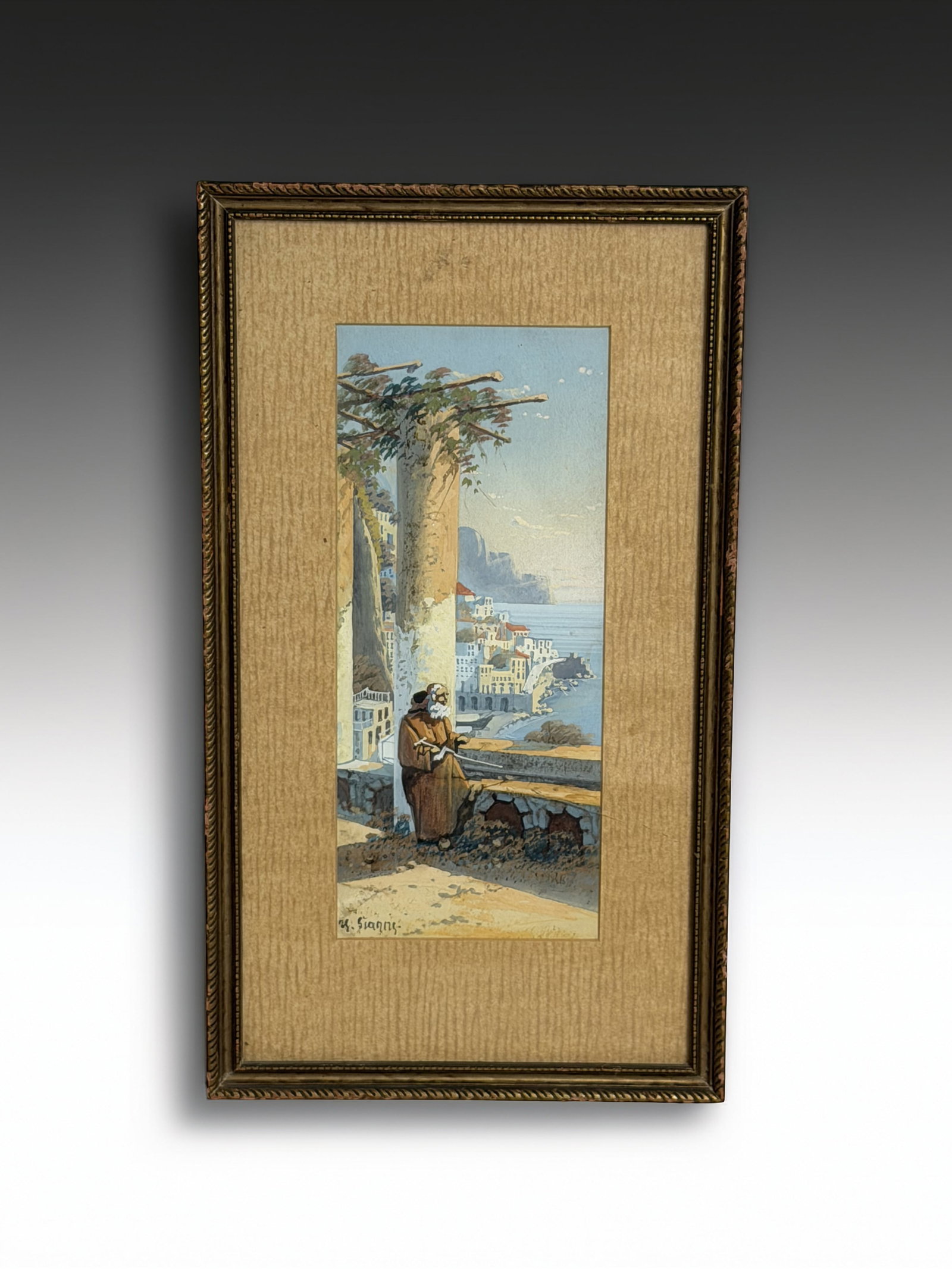 G. Gianni Signed Italian Coastal Landscape Watercolor: A charming coastal watercolor signed ?G. Gianni,? depicting an Italian seaside village viewed from a hilltop terrace. The composition includes a monk or traveler seated beneath tall cypress trees,