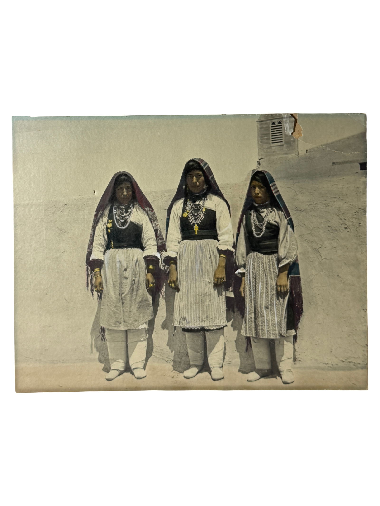 Vintage Ethnographic Photograph: Hand-colored vintage photograph depicting three women in traditional dress. Damages