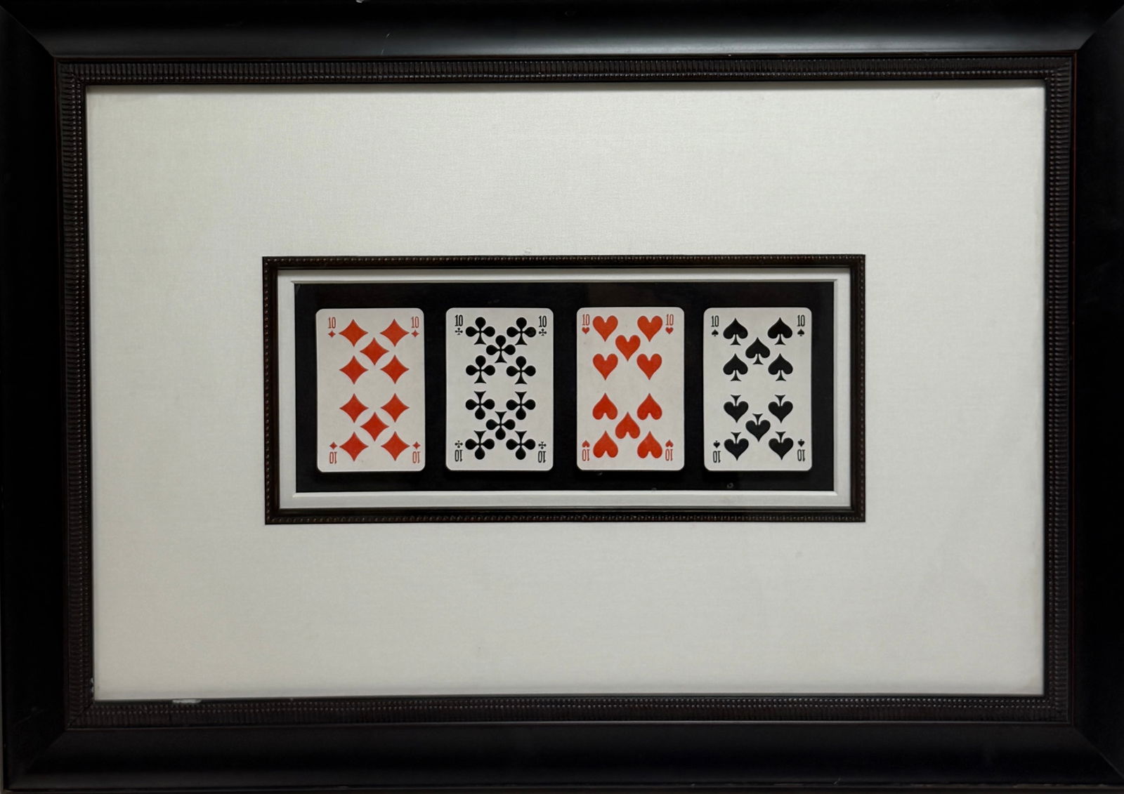 Framed Vintage Playing Cards Display: Decorative framed arrangement of four playing cards