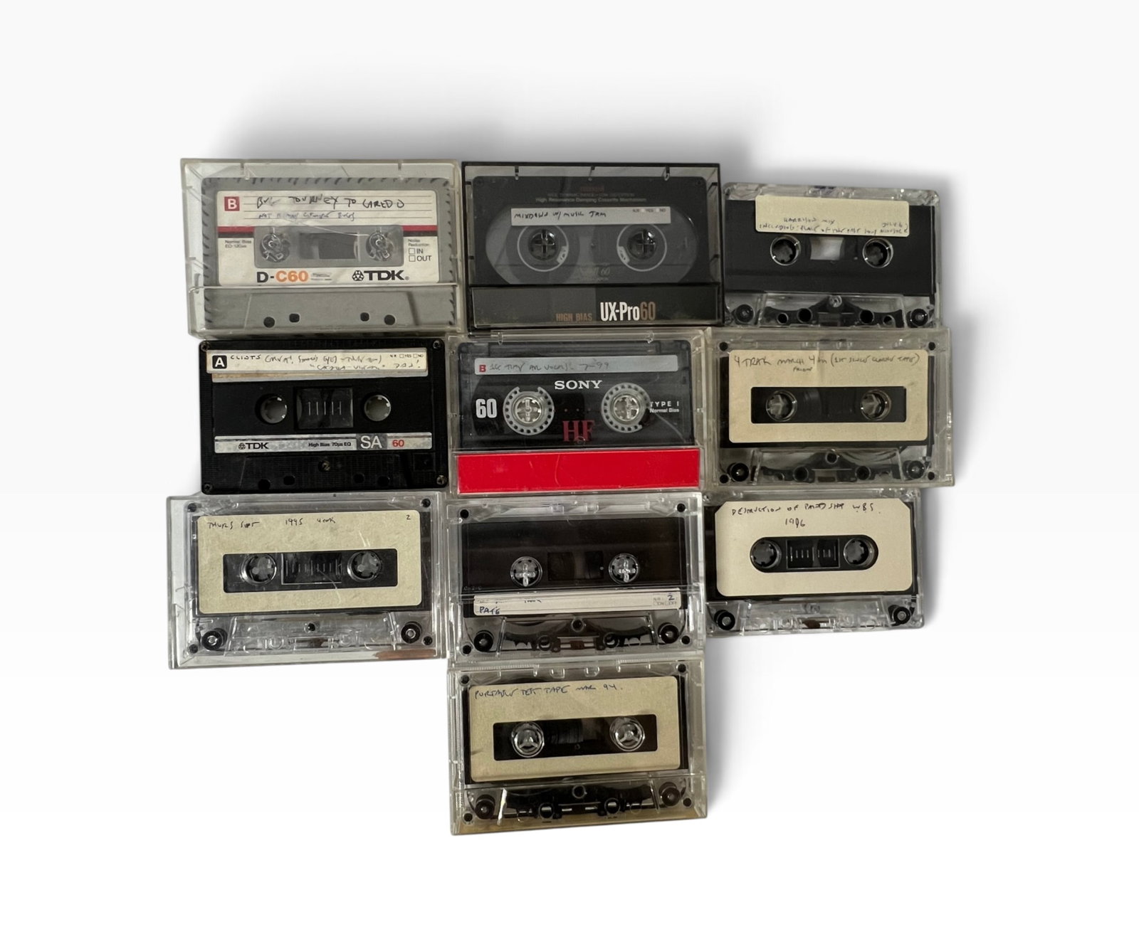Vintage Studio Punk Rock Cassette Tape Archive 1980s90s: Group of vintage recorded cassette tapes in cases, including TDK, Maxell, Sony and other brands. Handwritten labels reference masters, mixes, rehearsals and various dated recording sessions from the 1
