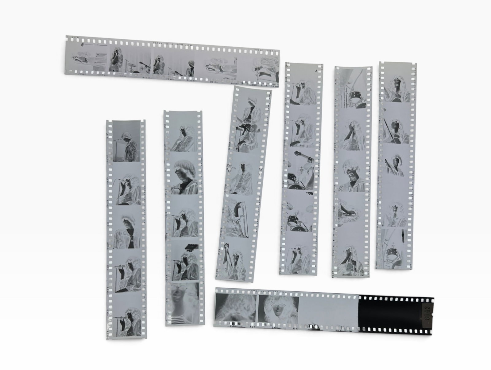 Vintage Music Performance 35mm Film Negative Strips Archive Lot: Collection of vintage 35mm black-and-white/negative film strips showing musicians and live performance scenes, including singers, guitarists and drummers. Multiple strips with several frames each. Ori