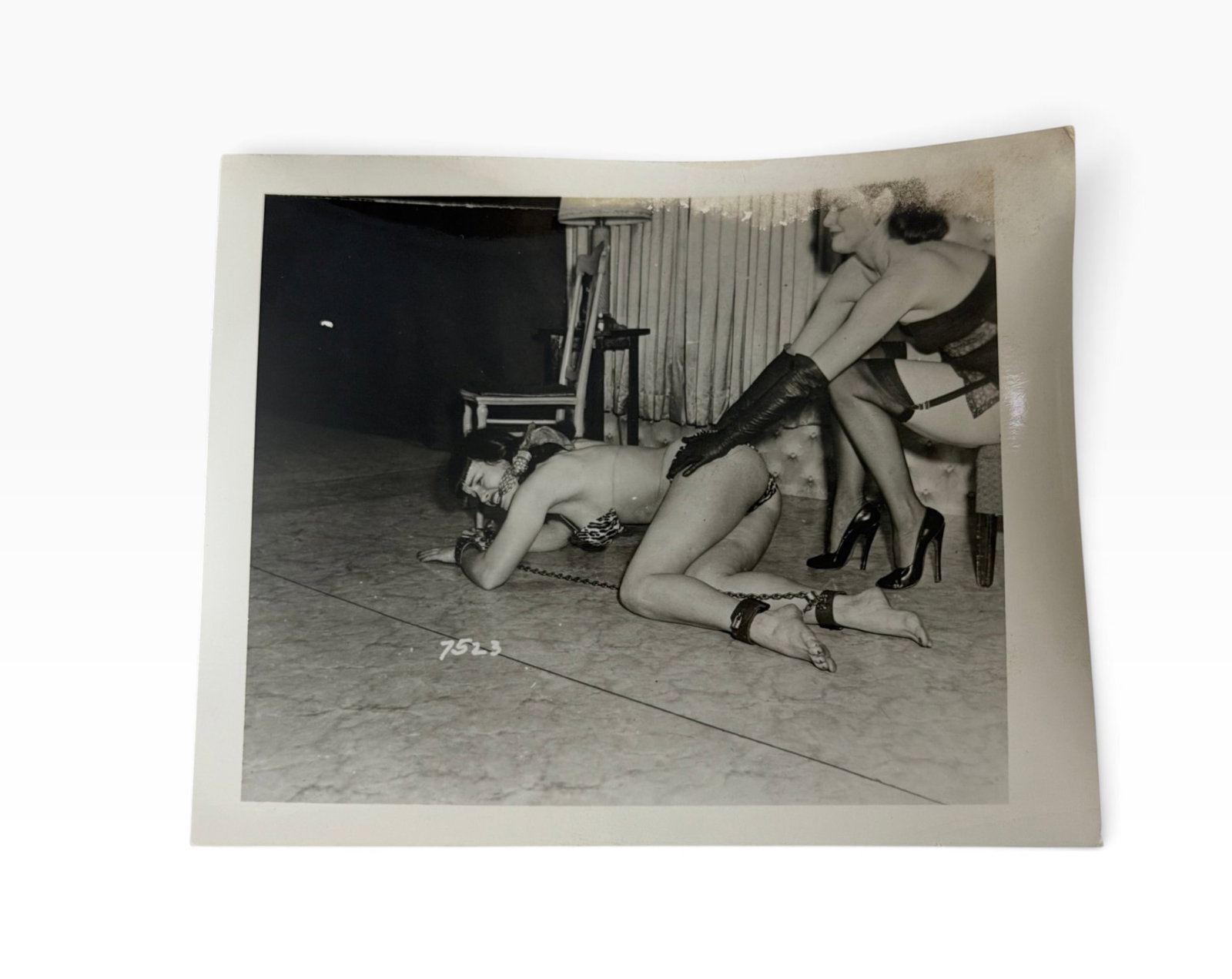 Vintage BlackandWhite Adult Photograph Bettie Page: Original vintage black-and-white glossy photograph depicting a staged adult scene. Image bears production/reference number 7523. Some visible age and edge wear.