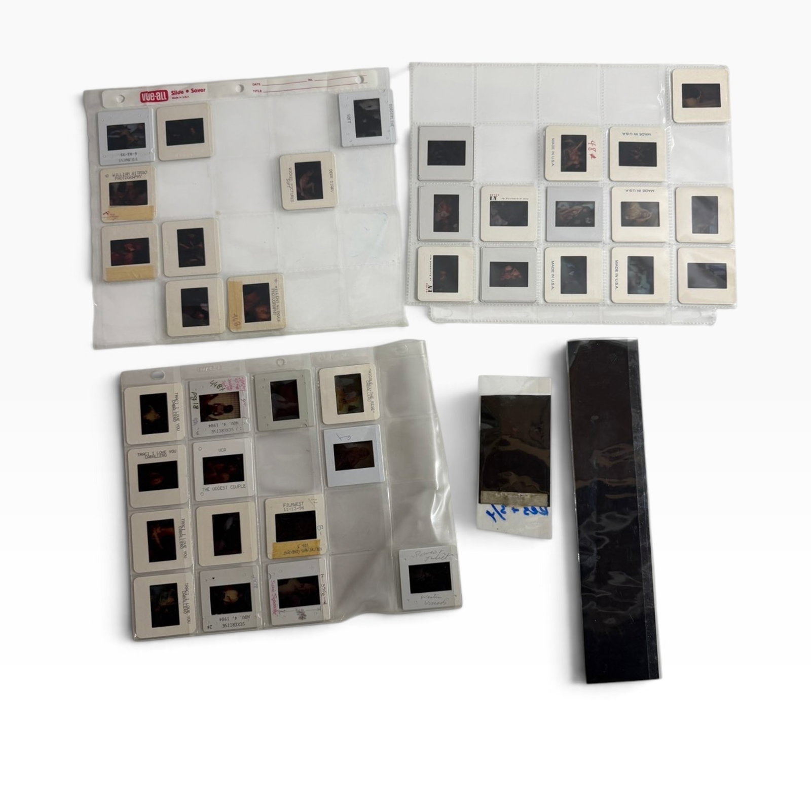 Vintage Adult Color Slide Archive Mounted Slides Film Strips: Mixed archive of vintage mounted color slides and film strips housed in plastic slide pages/sleeves. Adult-themed photographic material; untested and sold as found.