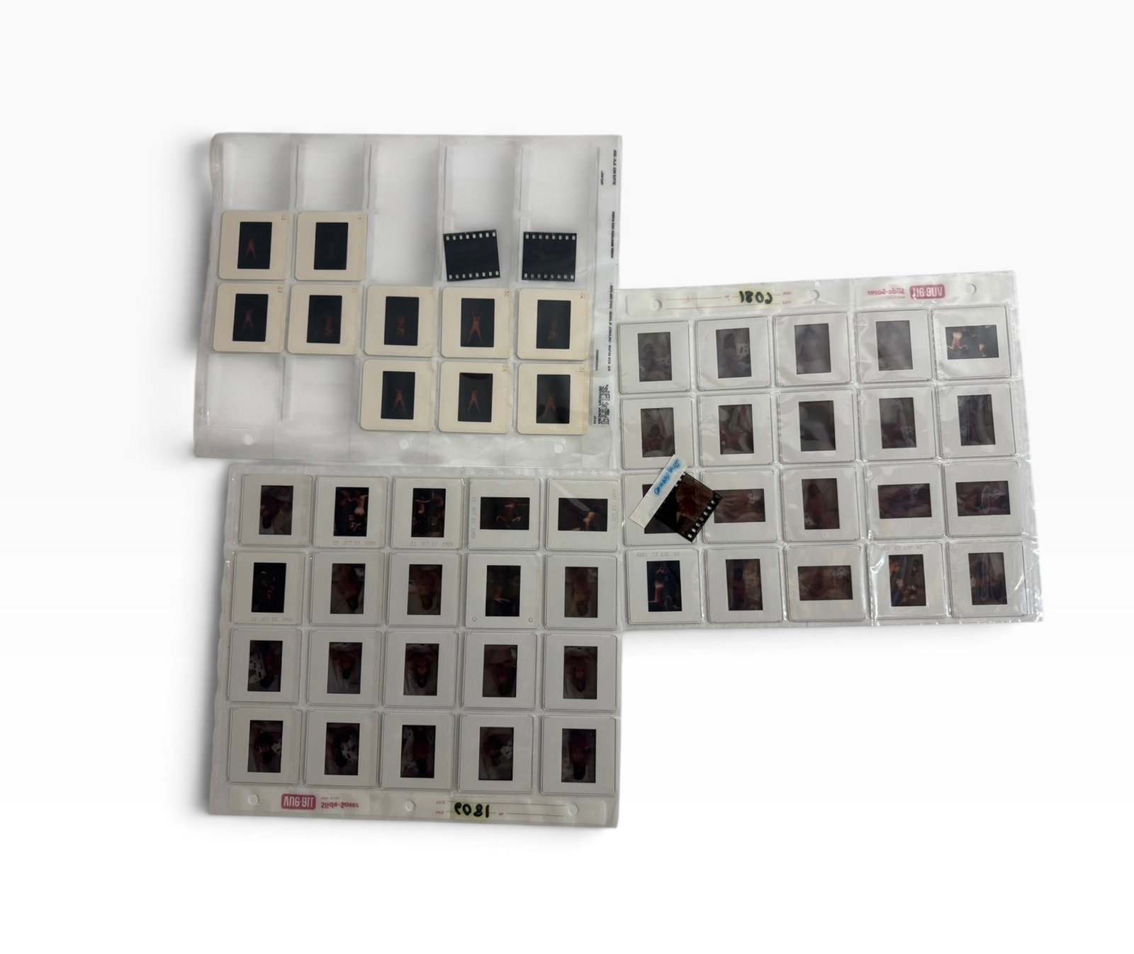 Vintage Adult Color Slide Collection Multiple Archival Pages: Group of vintage mounted color slides in plastic storage pages, including portrait and adult glamour imagery. Various mounts and dates/notations visible. Sold together as shown.