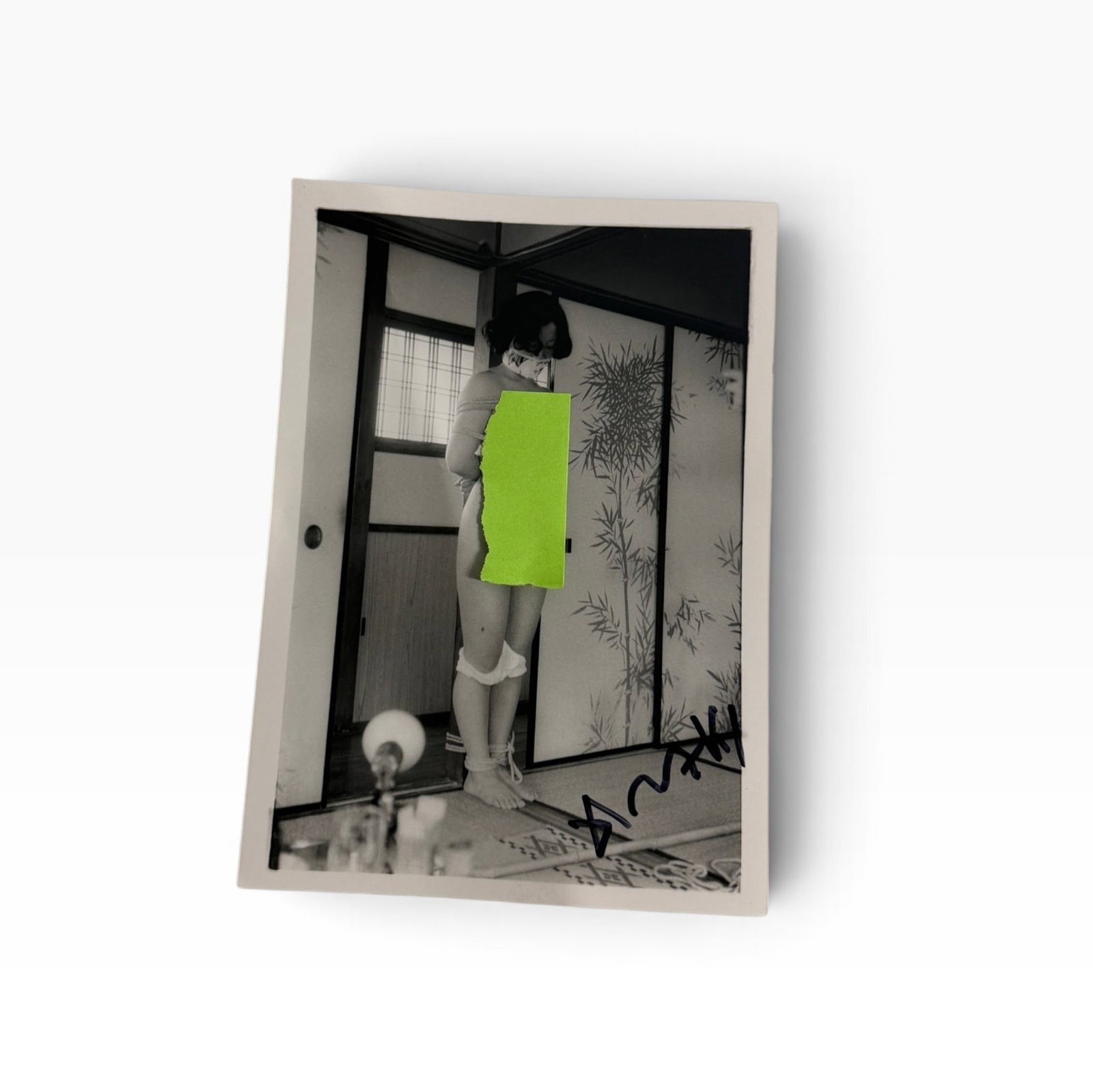 Vintage BlackandWhite JapaneseStyle Photograph Signed Nobuyoshi Araki: Vintage black-and-white photograph signed Nobuyoshi Araki depicting a staged Japanese-style adult scene. Bears a bold ink signature or notation at the lower right. Sold as shown.