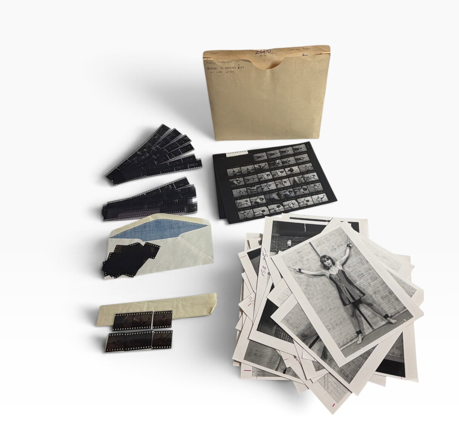 Vintage Adult Nude Photo Archive Negatives Contact Sheet: Vintage photography archive with original envelope, black-and-white prints, contact sheet, and multiple negative strips. Adult studio imagery; untested and sold as found.