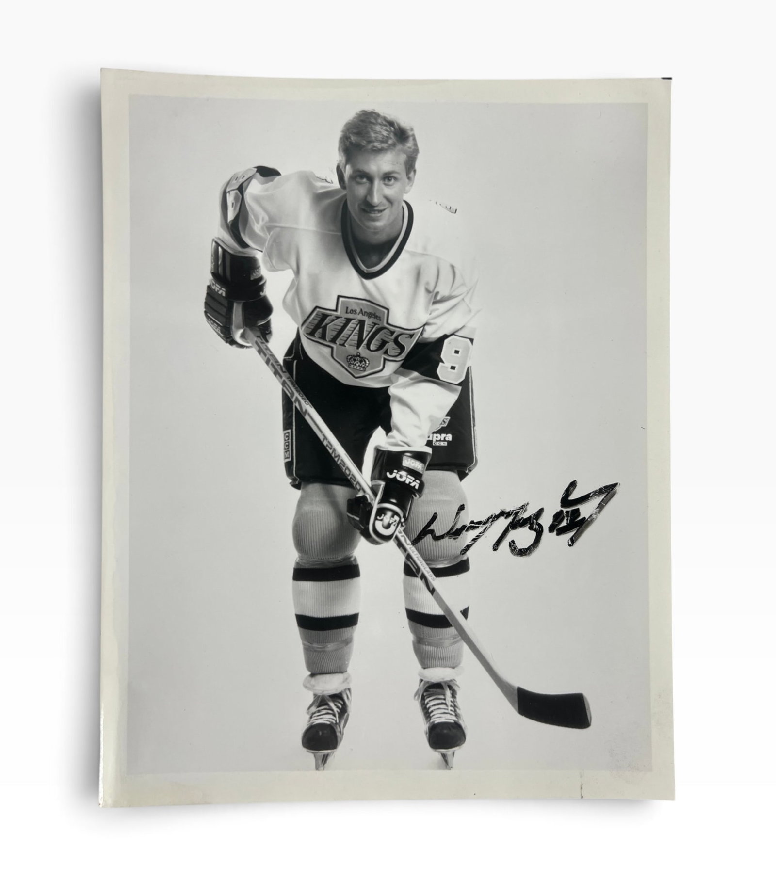 Signed Los Angeles Kings 99 Hockey Photograph by Wayne Gretzky: Black-and-white promotional-style photograph depicting a Los Angeles Kings hockey player wearing jersey number 99, bearing a bold handwritten signature in black ink. Signature has not been independent