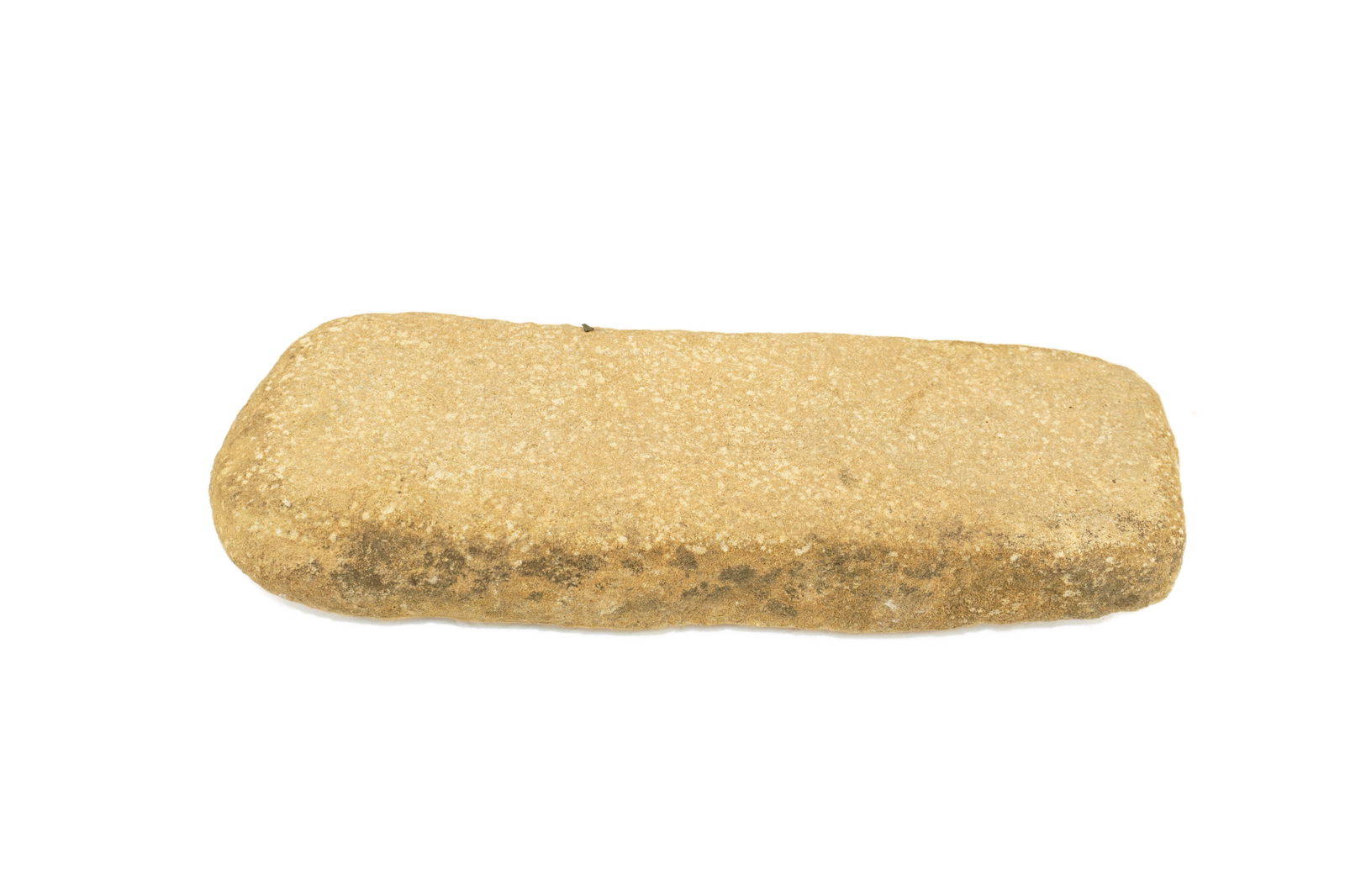 Native American Grinding stone (Mano): A hand-held grinding stone, or mano, shaped from a pale tan sedimentary stone with a consistent, gritty texture. Rectangular in form with softly rounded edges. This tool represents the essential