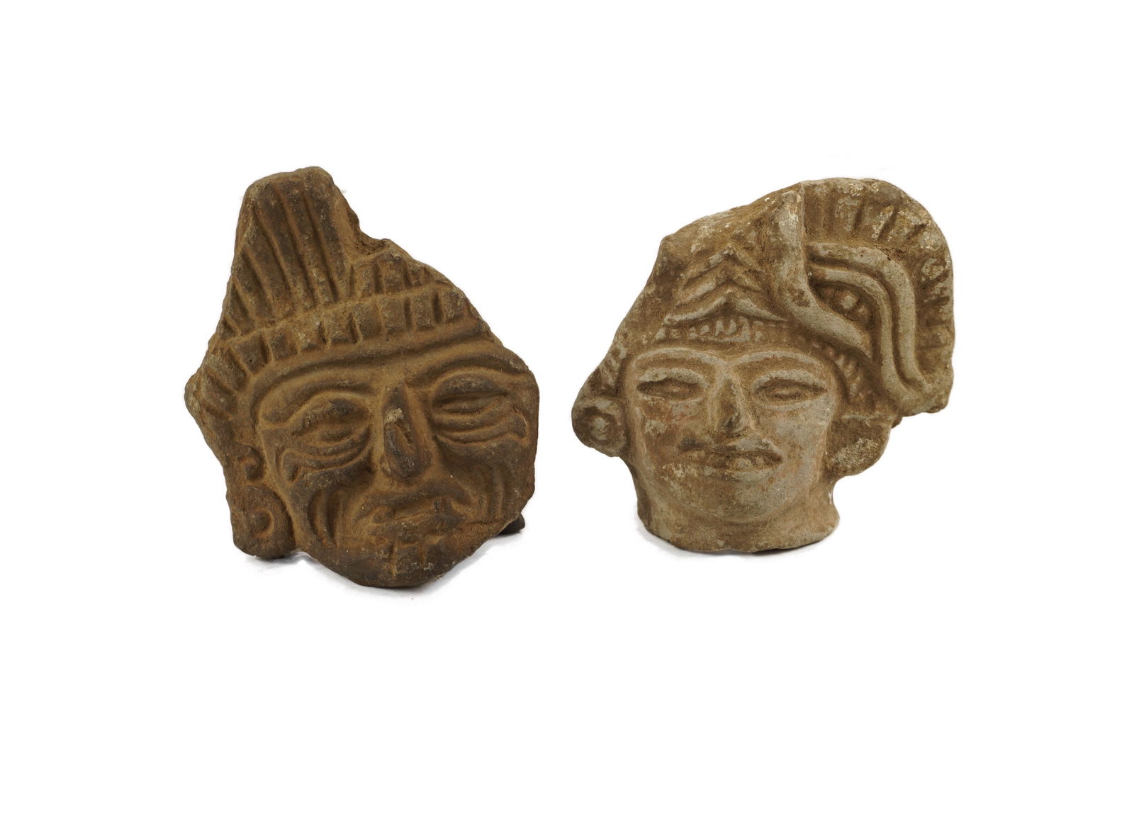 Pre columbian Figural Heads: 900 - 1500 CE. A pair of pre columbian figural heads. These are often faked, but the real ones are unmistakable. These were often buried as offerings and are later recovered during building or