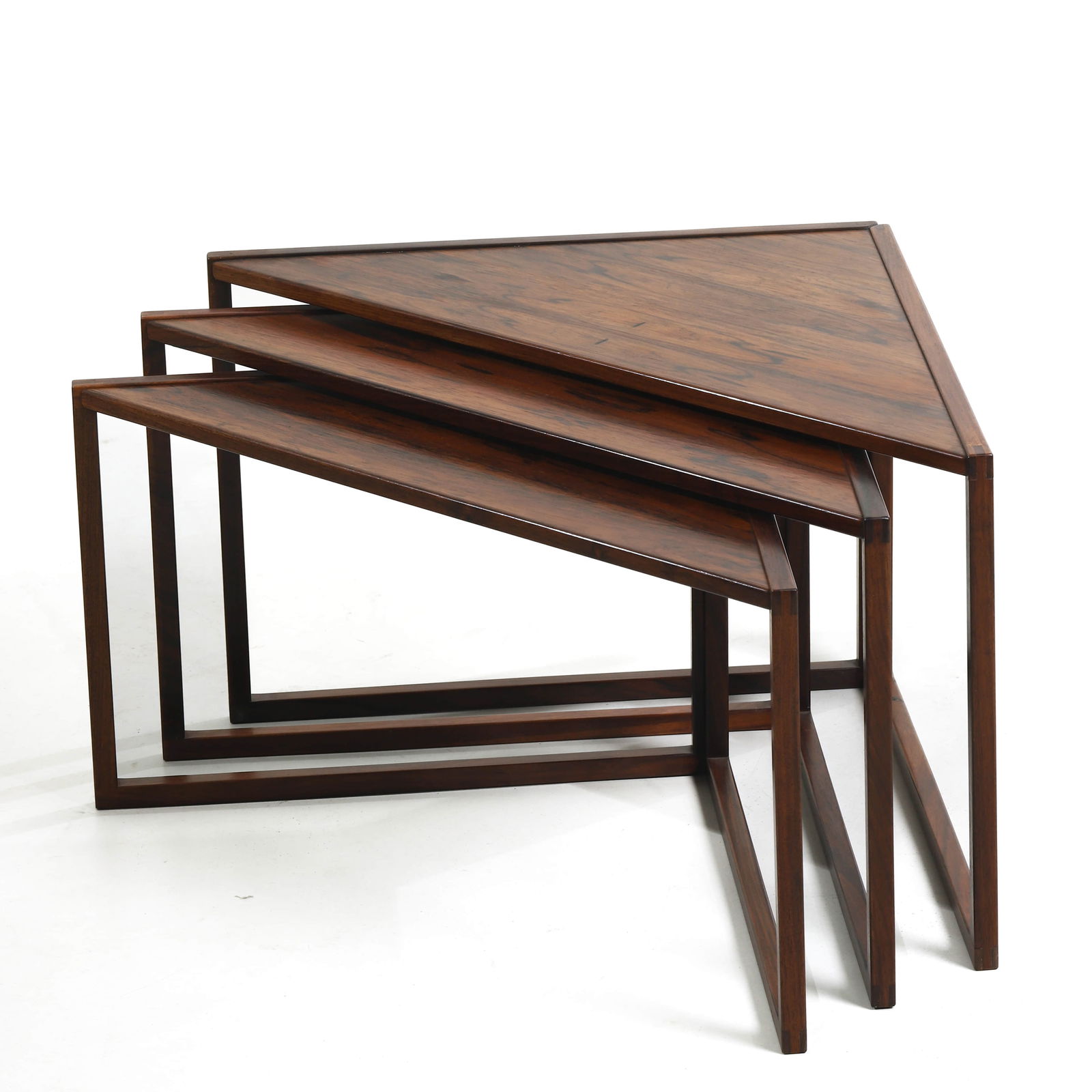 TRIANGULAR NESTING TABLES BY KAI KRISTIANSEN (VILDBJERG MØBELFABRIK, DENMARK): Dimensions (Largest Table) Length: 33 1/8 in. (84 cm); Width: 23 5/8 in. (60 cm); Height: 17 3/8 in. (44 cm) Description A refined set of triangular nesting tables designed by Kai Kristiansen and prod
