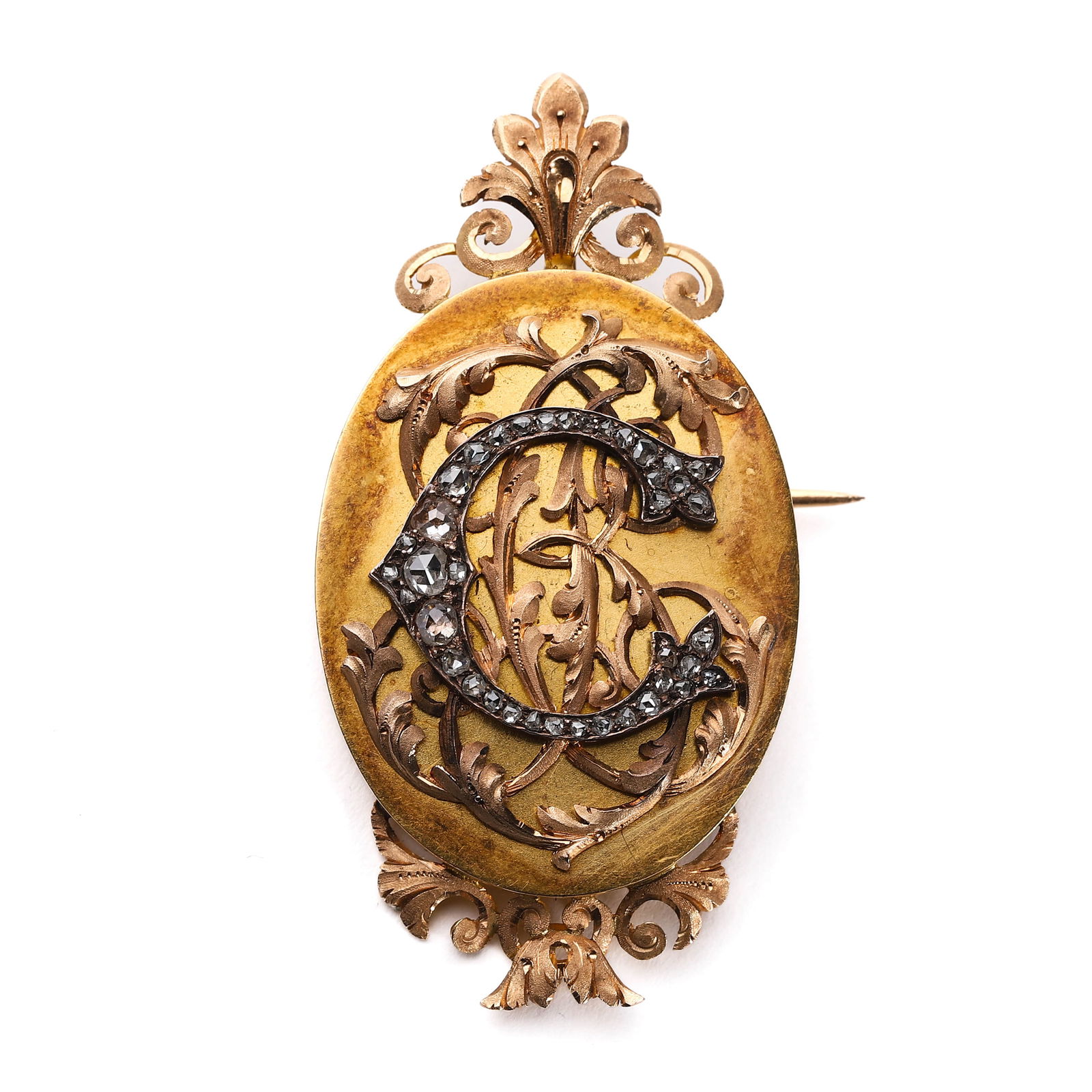 VICTORIAN DIAMOND MONOGRAM BROOCH: Dimensions: Length: 2 1/8 in. (53.5 mm), Width: 1 1/16 in. (27.5 mm), Weight: 16.4 g Description: A Victorian period brooch with an ornate openwork frame and applied floral repoussé detailing. The