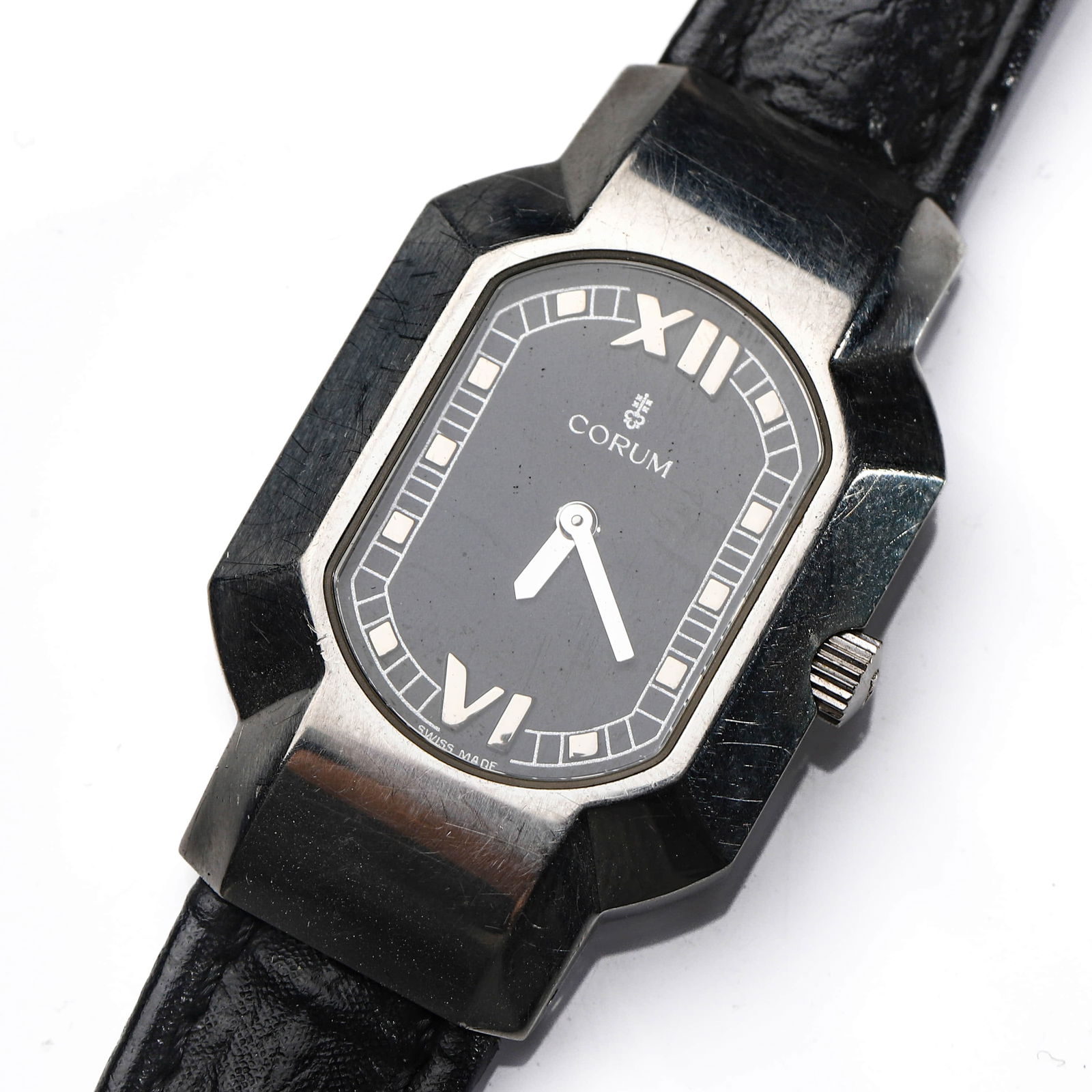 CORUM RECTANGULAR WRISTWATCH: Dimensions Overall length approx. 8 1/16 in (20.5 cm).Dial diameter approx. 1 in (25.5 mm). Description A Swiss wristwatch by Corum, featuring a distinctive rectangular stainless steel case with