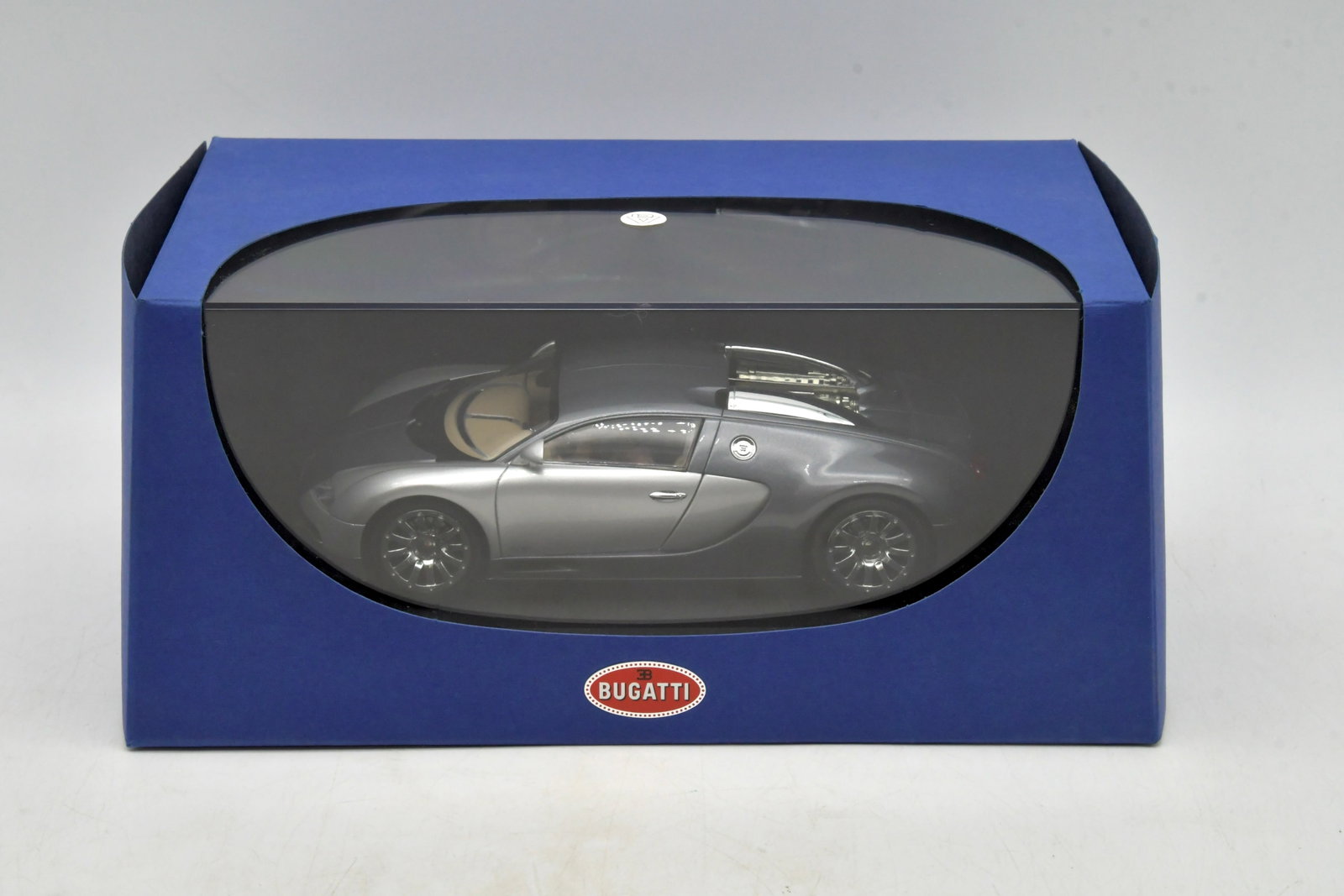 AUTOart Bugatti EB16.4 Veyron 1/24 Diecast Model: AUTOart Bugatti EB16.4 Veyron "Geneva Show Car 2003" detailed 1:24 scale diecast display model, finished in grey/silver. Highly detailed collector model with accurate body lines, interior detail, and