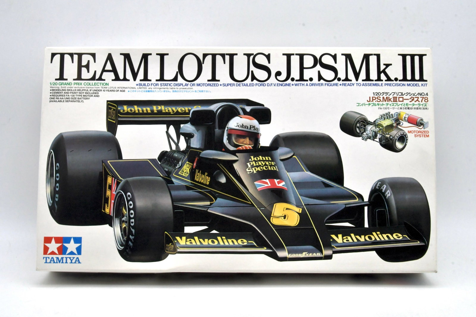 Tamiya Team Lotus JPS Mk.III 1/20 Kit: Tamiya Team Lotus J.P.S. Mk.III Formula One plastic model kit in 1/20 scale from the Grand Prix Collection No.4. John Player Special blackandgold livery version with detailed DFV engine and driver fig
