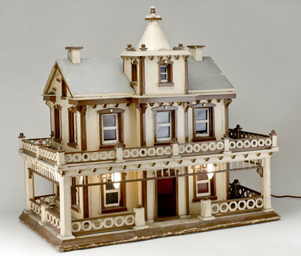 Victorian Italian Style Doll House: Circa 1910, two story cream and brown painted doll house, electrified, the rear opening to reveal four rooms. Measures 30 1/2" x 30" x 18 1/2".