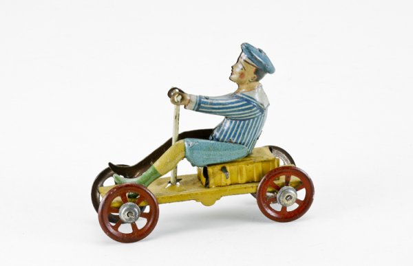German Mechanical Boy on Cart Penny Toy: Lithographed, with stamped in Meier insignia.