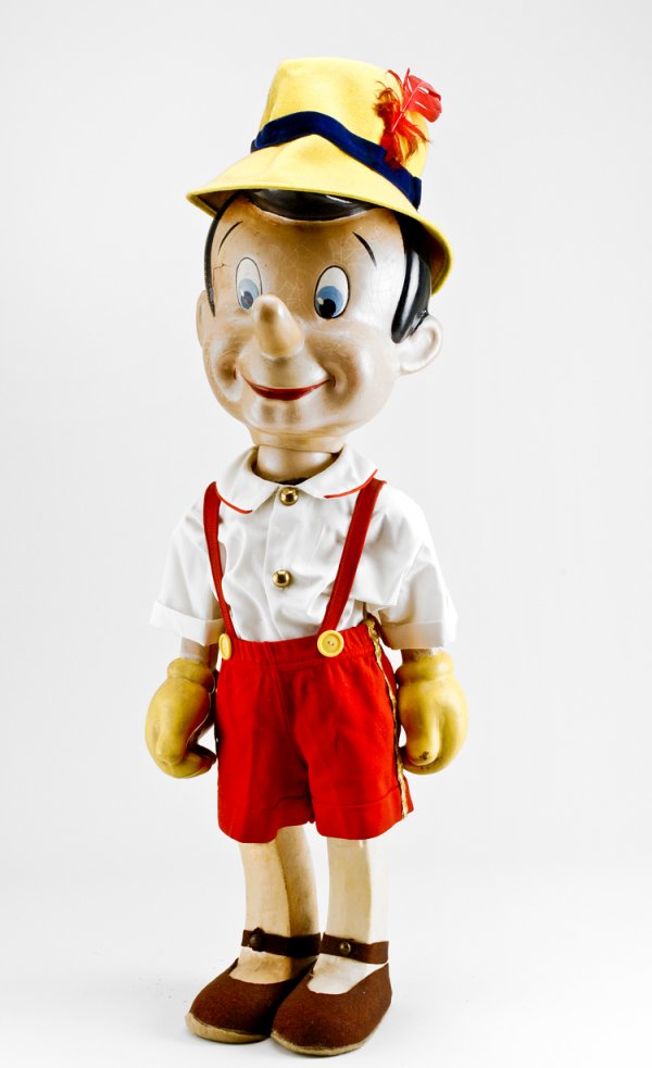 Large Composition Pinocchio: By Crown Manufacturing Co., circa 1940, most likely a store display. Jointed body with Kay Kamen label on back. 34" tall. Previously sold at Christie's 1988 Toy auction.