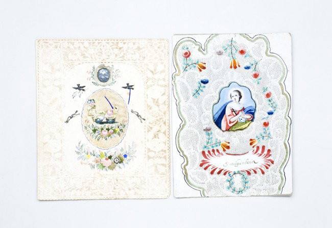 2 Early Valentines: Child done paper valentine measuring 9 7/8" x 7 7/8" with a center silk medallion. Hand painted with scrap additions. Hand written note inside "Catherine Wanner Reeser: First Valentine". Appearing to 