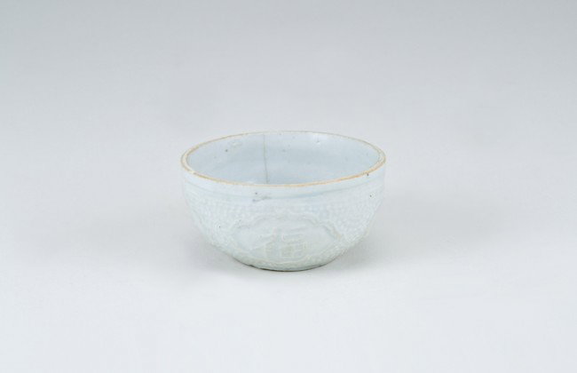 Ancient Chinese Cup: 2 3/4" diameter. Labeled as: Sung, Ching-Pai Cup with Molded Decoration. From a collection of Chinese Sung, Tang and Han Dynasty pottery, all originating from the construction site of the Three Gorges