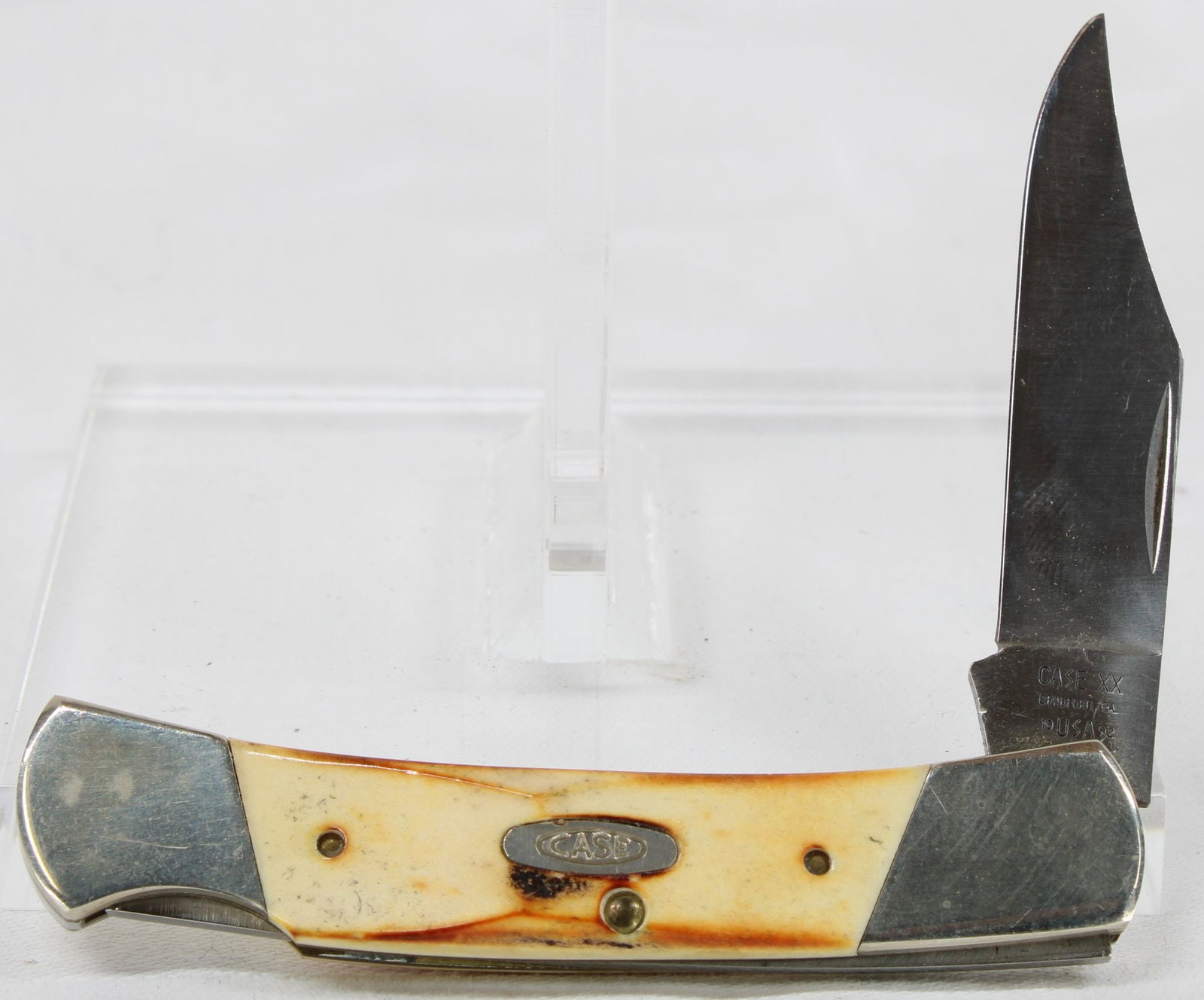Case XX Folding Lockback Hunter Knife: Case XX folding lockback hunter knife featuring a single locking clip blade, bone handles, Case shield, and nickel silver bolsters. Knife shows light handling wear with minor surface scratches and lig