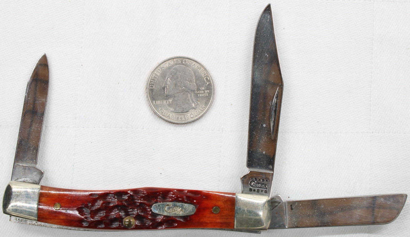 Case XX 3-Blade Stockman Pocket Knife: Three-blade stockman pocket knife with red jigged bone handles and Case shield. Tang stamped Case XX USA. Blades show light wear and minor surface marks from use. Handles appear solid. Nice collectibl