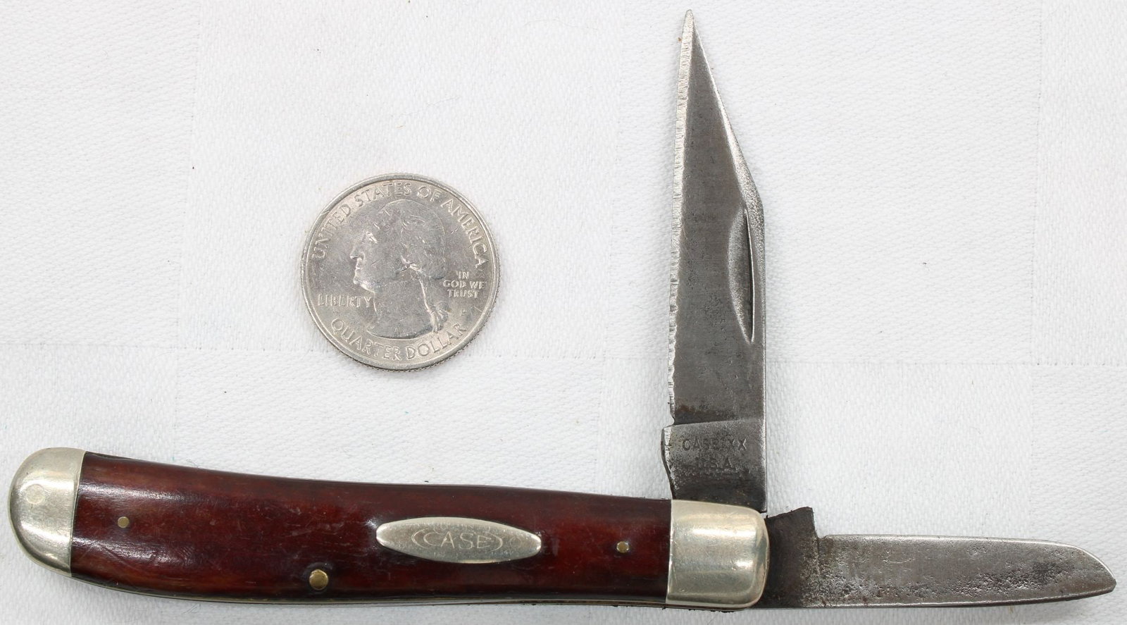 Case XX 2-Blade Folding Pocket Knife - Brown Handle: Two-blade folding pocket knife with smooth brown composition handles and Case shield. Tang stamped Case XX USA. Blades show wear, patina, and oxidation consistent with age and use. Handles appear soli