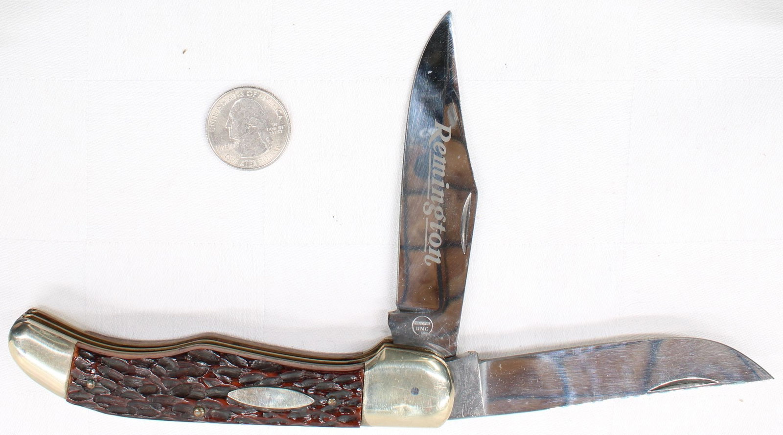 Remington Pocket Knife- 2 Blade: Remington UMC two-blade folding pocket knife featuring jigged brown composition handles, brass bolsters, and oval shield. Includes clip point master blade with Remington blade etch and secondary pen b