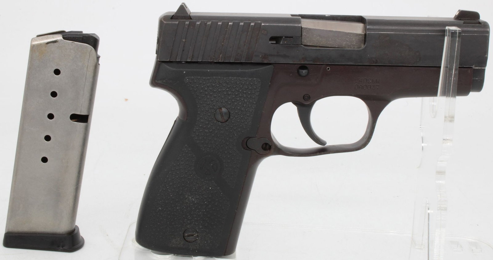 Kahr Arms K40 .40 S&W Semi-Automatic Pistol w/ Magazine: Kahr K40 semi-automatic pistol chambered in .40 S&W with stainless steel frame and slide. Features double-action-only trigger, fixed sights, textured grip panels, and compact concealed-carry profile. 