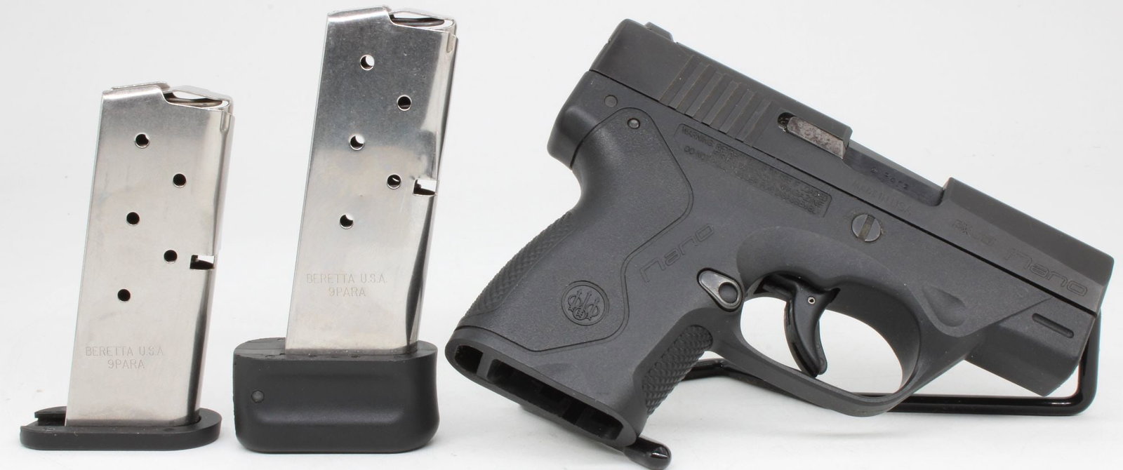 Beretta Nano 9mm Semi-Automatic Pistol w/ Magazines: Beretta Nano semi-automatic pistol chambered in 9mm Parabellum with compact polymer frame and matte black slide. Features striker-fired action, low-profile fixed sights, textured grip, and snag-free d