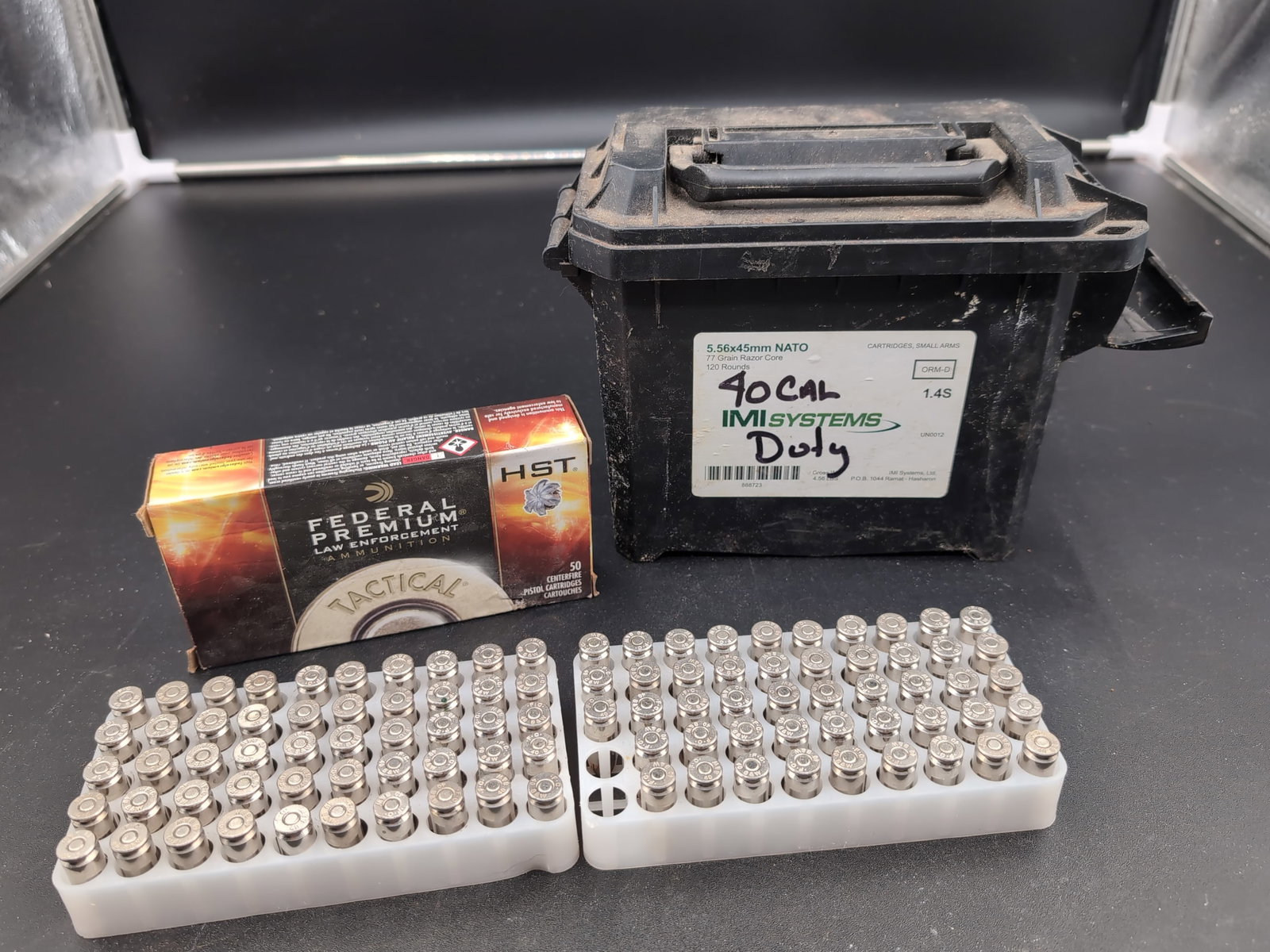 Federal Premium Law Enforcement 40 S&W 180 Grain HST Tactical Ammunition: A collection of Federal Premium Law Enforcement 40 S&W 180 grain HST Tactical ammunition. The lot includes one original box and loose cartridges housed in plastic loading trays. Also included is a bla