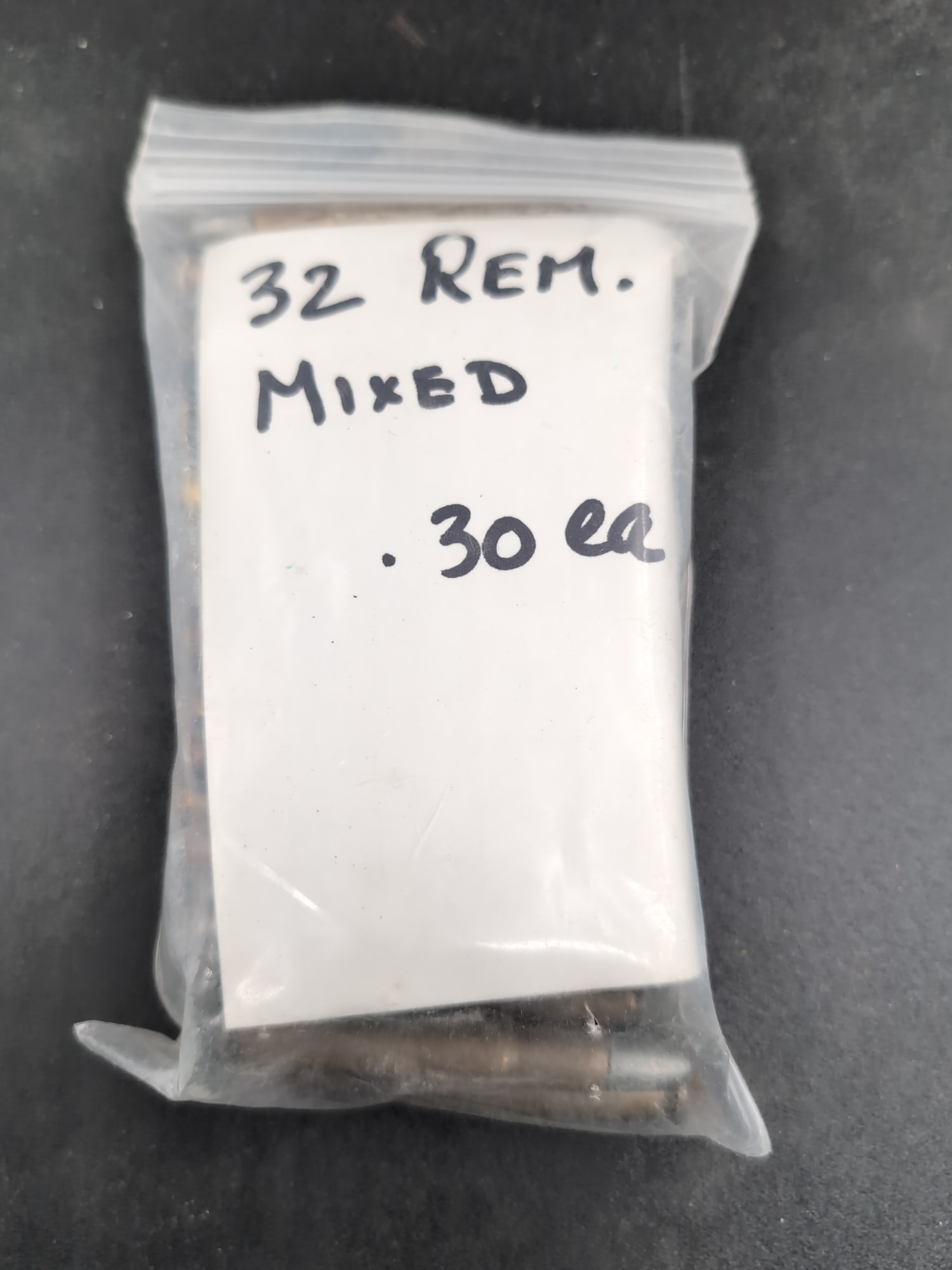 Assorted .32 Remington Rifle Cartridges, Quantity of 30: A collection of 30 mixed .32 Remington rifle cartridges contained in a plastic storage bag. The lot includes various bullet types and casing finishes as shown in the provided images.