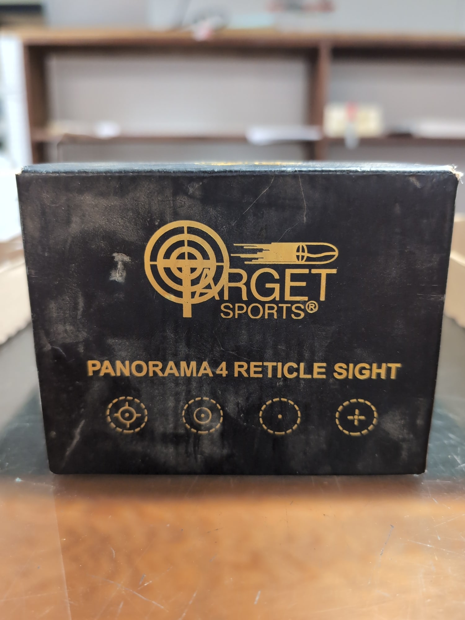 Target Sports Panorama 4 Reticle Sight: A Target Sports Panorama 4 reticle sight featuring four selectable reticle patterns. The unit includes an integrated mounting base and is presented in its original foam-lined storage box.