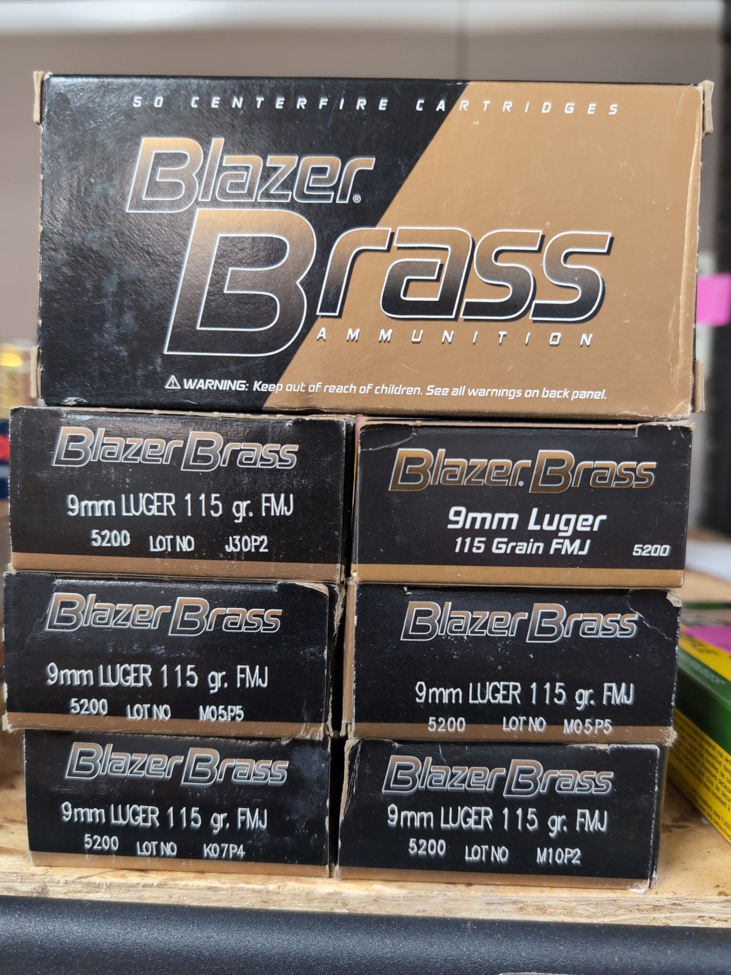 Blazer Brass 9mm Luger 115 Grain FMJ Ammunition, 6 Boxes: A collection of six boxes of Blazer Brass 9mm Luger ammunition. Each box contains 50 centerfire cartridges with 115 grain Full Metal Jacket (FMJ) bullets. Lot numbers include J30P2, M05P5 (two boxes),