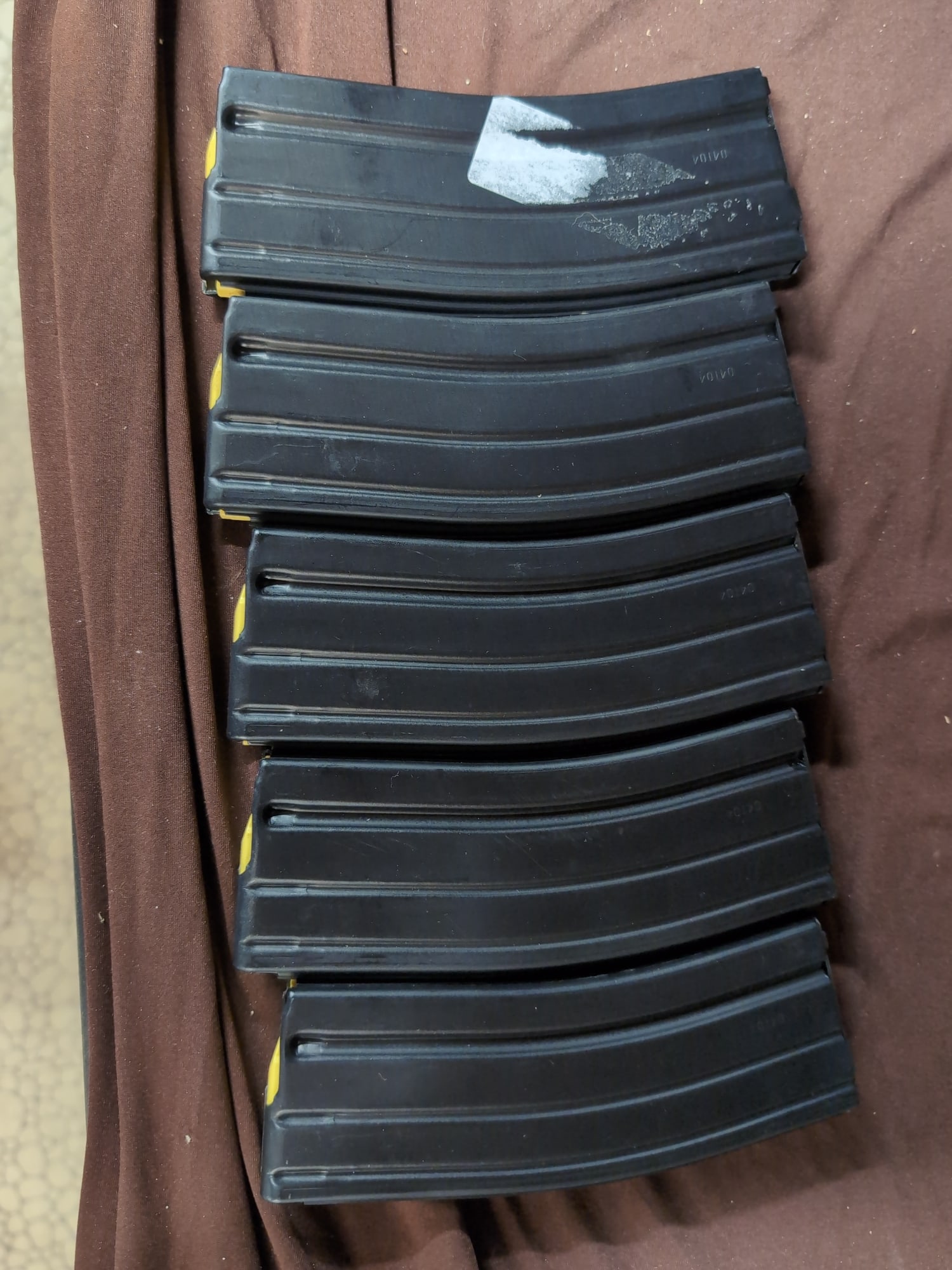 Set of Five D&H Industries 30-Round AR-15 Magazines: A lot of five D&H Industries, Inc. 30-round magazines for AR-15 platform rifles. Each magazine features a black finish and yellow follower. The base plates are stamped with the manufacturer name, loca