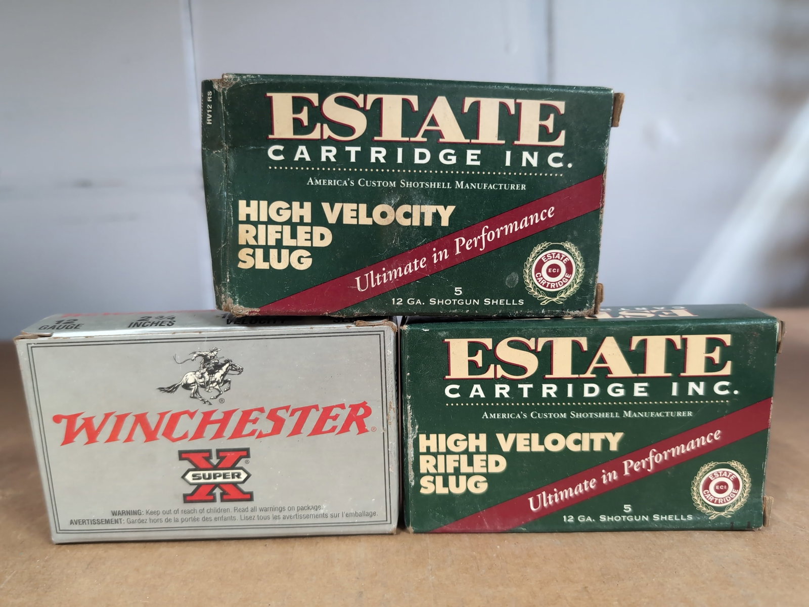 Assorted 12 Gauge Shotgun Slug Ammunition, 13 Total Rounds: A collection of 12 gauge shotgun slug ammunition consisting of three boxes. Included are two boxes of Estate Cartridge Inc. High Velocity Rifled Slugs (12 gauge, 2 3/4 inch, 1610 FPS) and one box of W