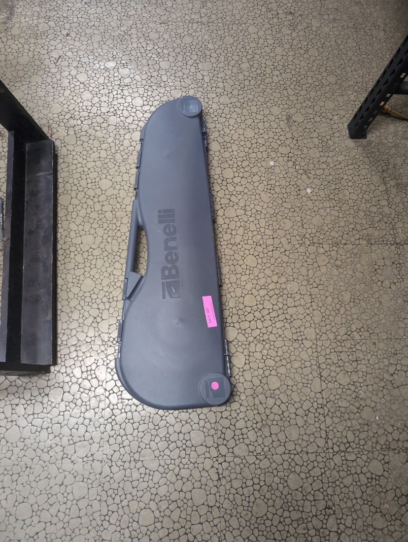Benelli Shotgun Hard Case with Choke Tubes and Accessories: A molded plastic hard-shell carrying case manufactured by Benelli. The interior features foam padding and molded compartments containing a camouflage-patterned shotgun barrel and forend, a set of mult
