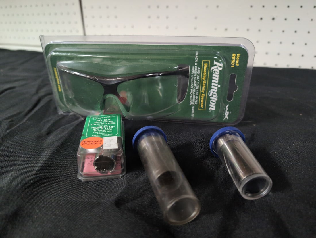 Remington Shooting Safety Eyewear and 20 Gauge Choke Tubes: This lot includes one pair of Remington branded shooting safety eyewear, model RE501, featuring ANSI Z87.1/EN 166 rating, black and green frame, and adjustable temples. Also included are three 20 gaug