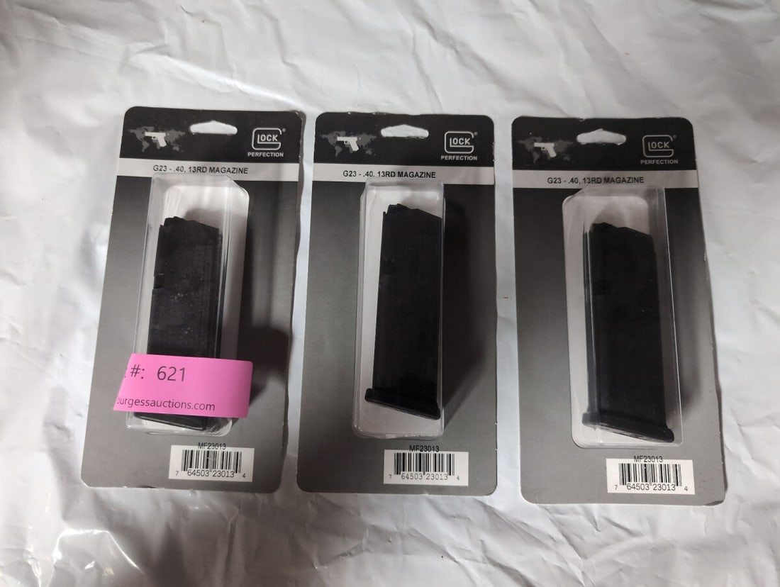 Three Glock G23 .40 Caliber 13-Round Magazines: A set of three factory-packaged Glock magazines, model G23, designed for .40 caliber ammunition. Each magazine features a 13-round capacity and remains sealed in original retail blister packaging.